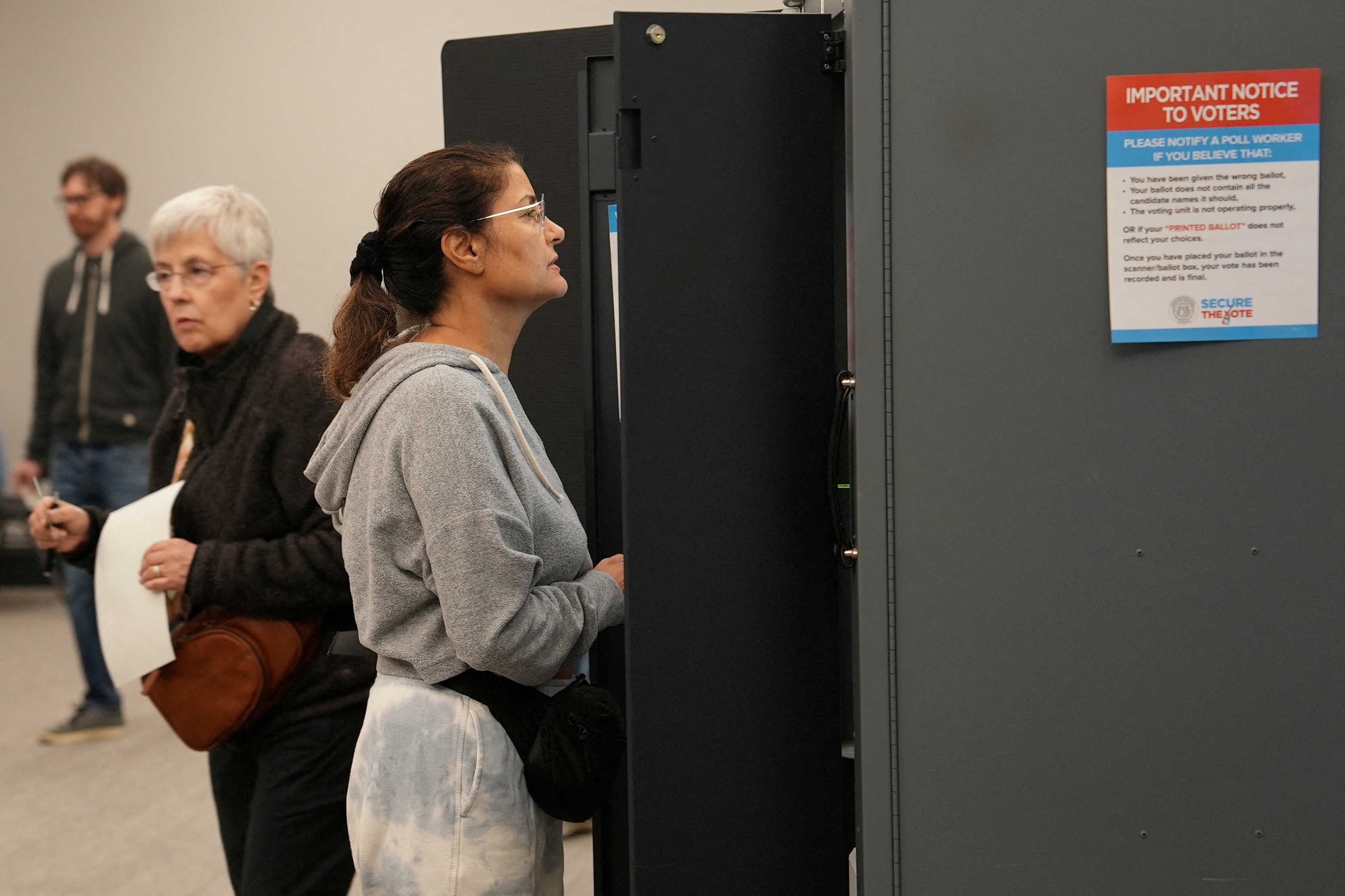 Voters take part in early election voting at a polling station in Marietta