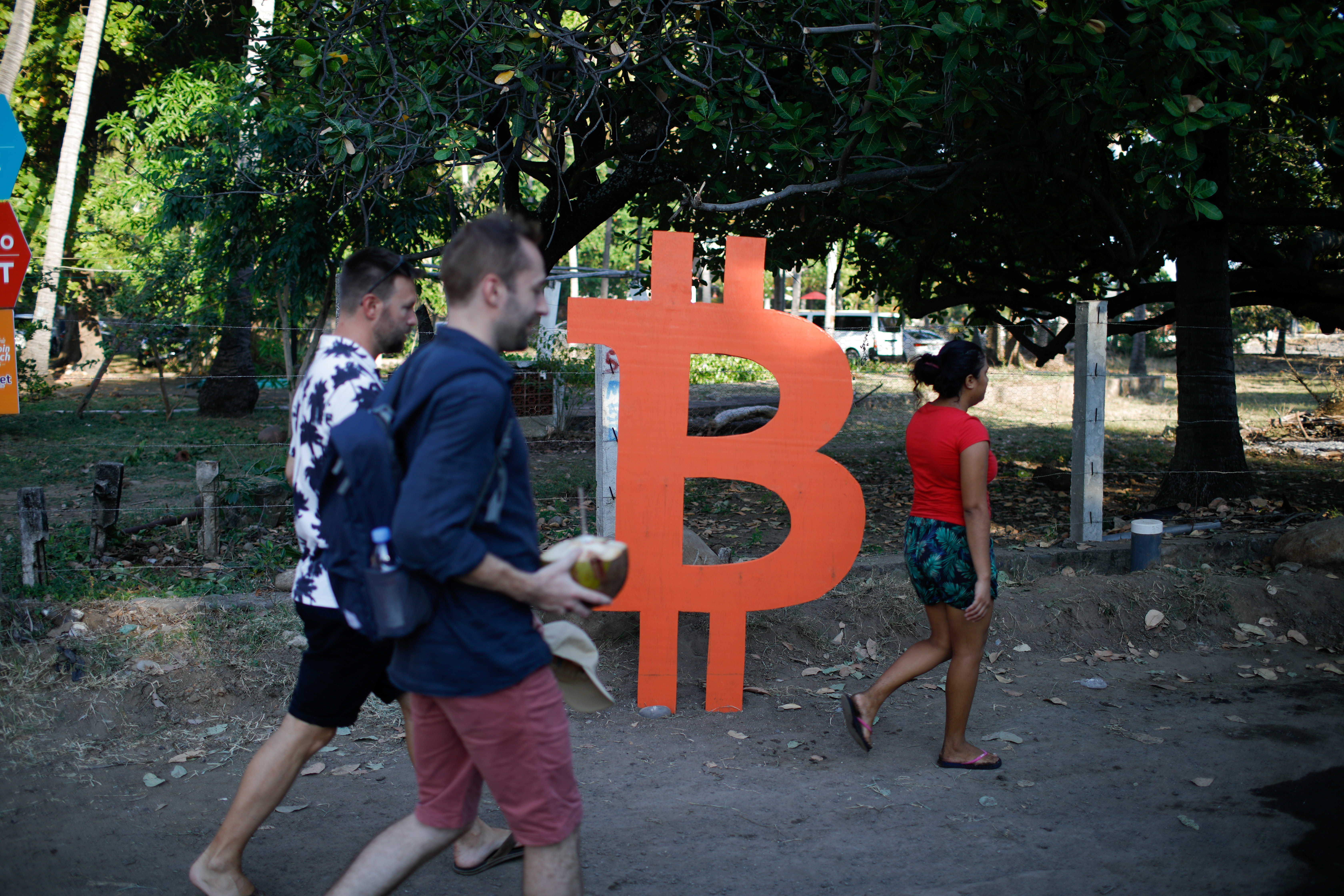 People participate in a meet up between local bitcoin users and foreigners at the closing of Adopting Bitcoin - A Lightning Summit in El Salvador at El Zonte Beach, in Chiltiupan