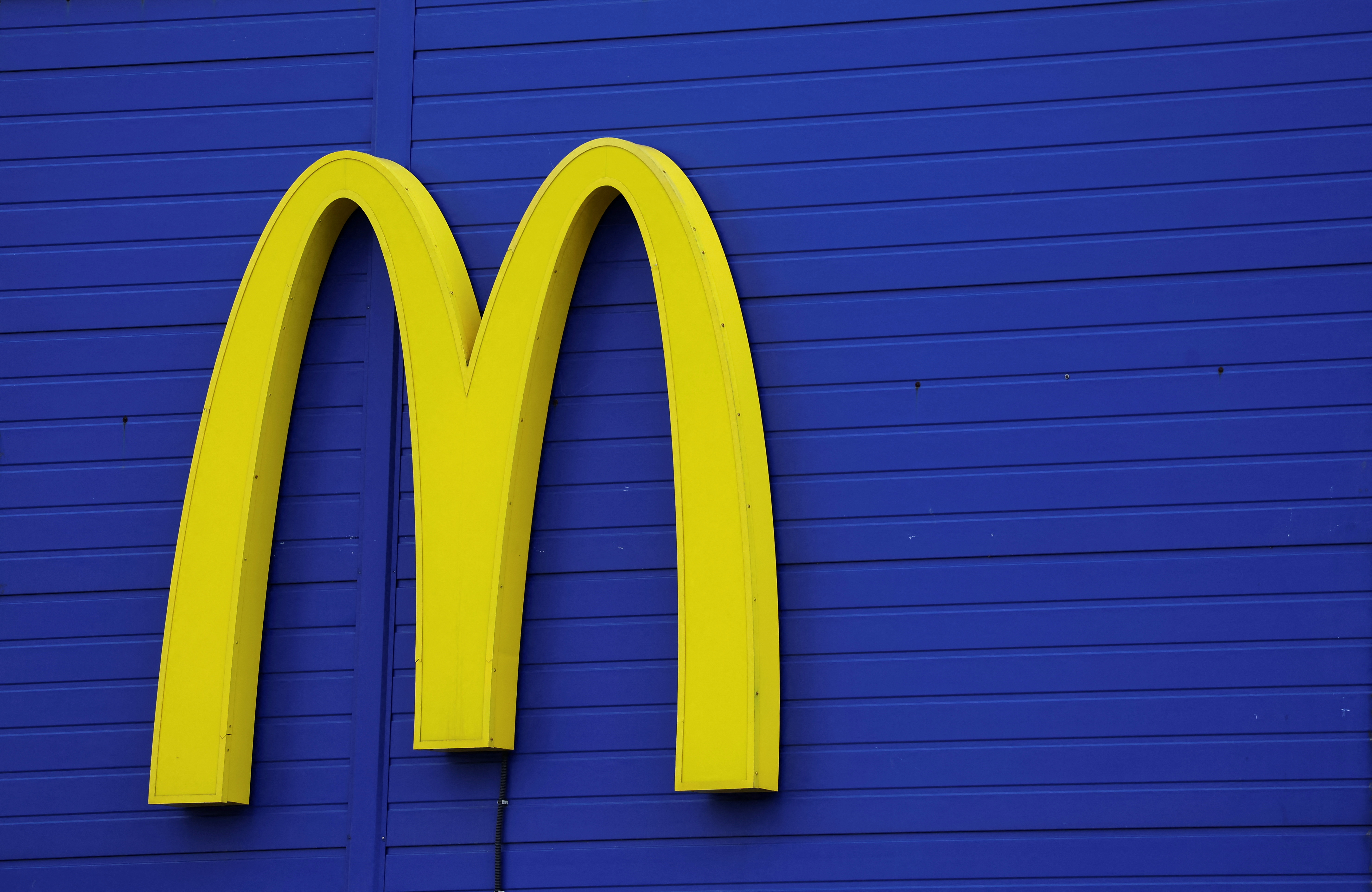 A sign with the logo is on display near a McDonald's restaurant in Moscow
