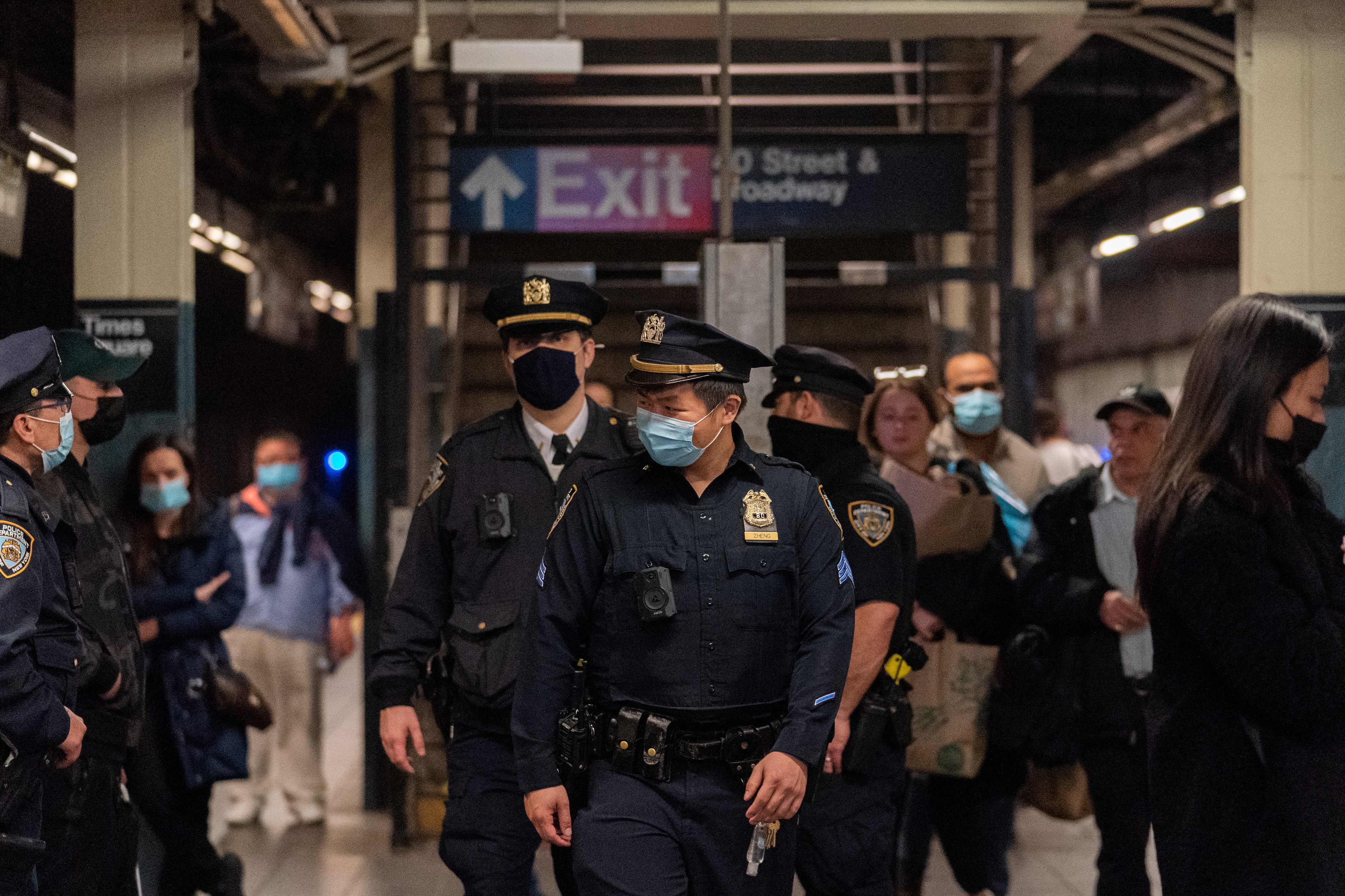 Police officers patrol in Times Square station, after a shooting at a subway station in Brooklyn borough, in Manhattan, New York City