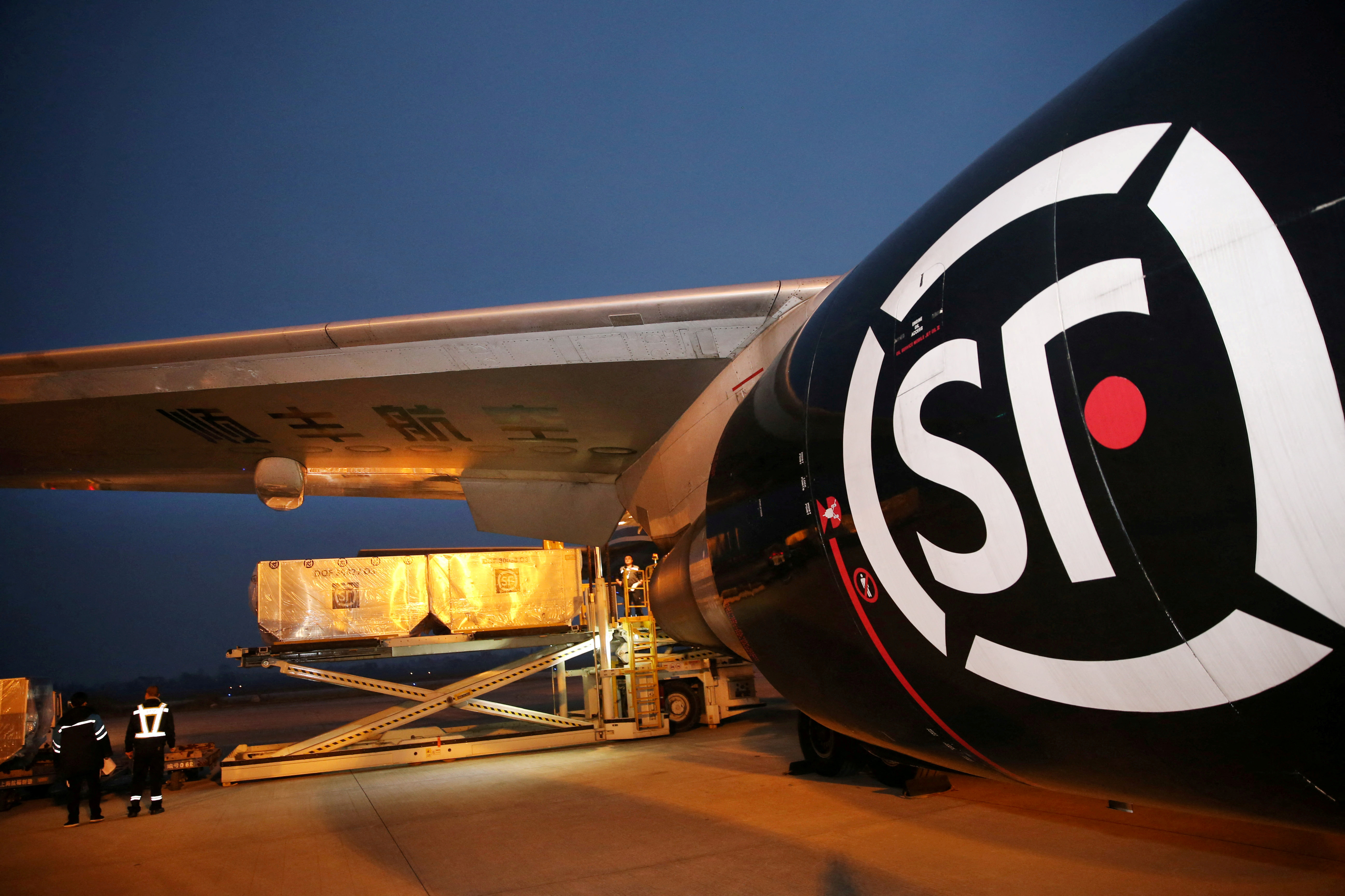 Employees load goods into a cargo aircraft of SF Airlines, owned by SF Express Co, after the Singles Day online shopping festival, at Nantong airport in Nantong