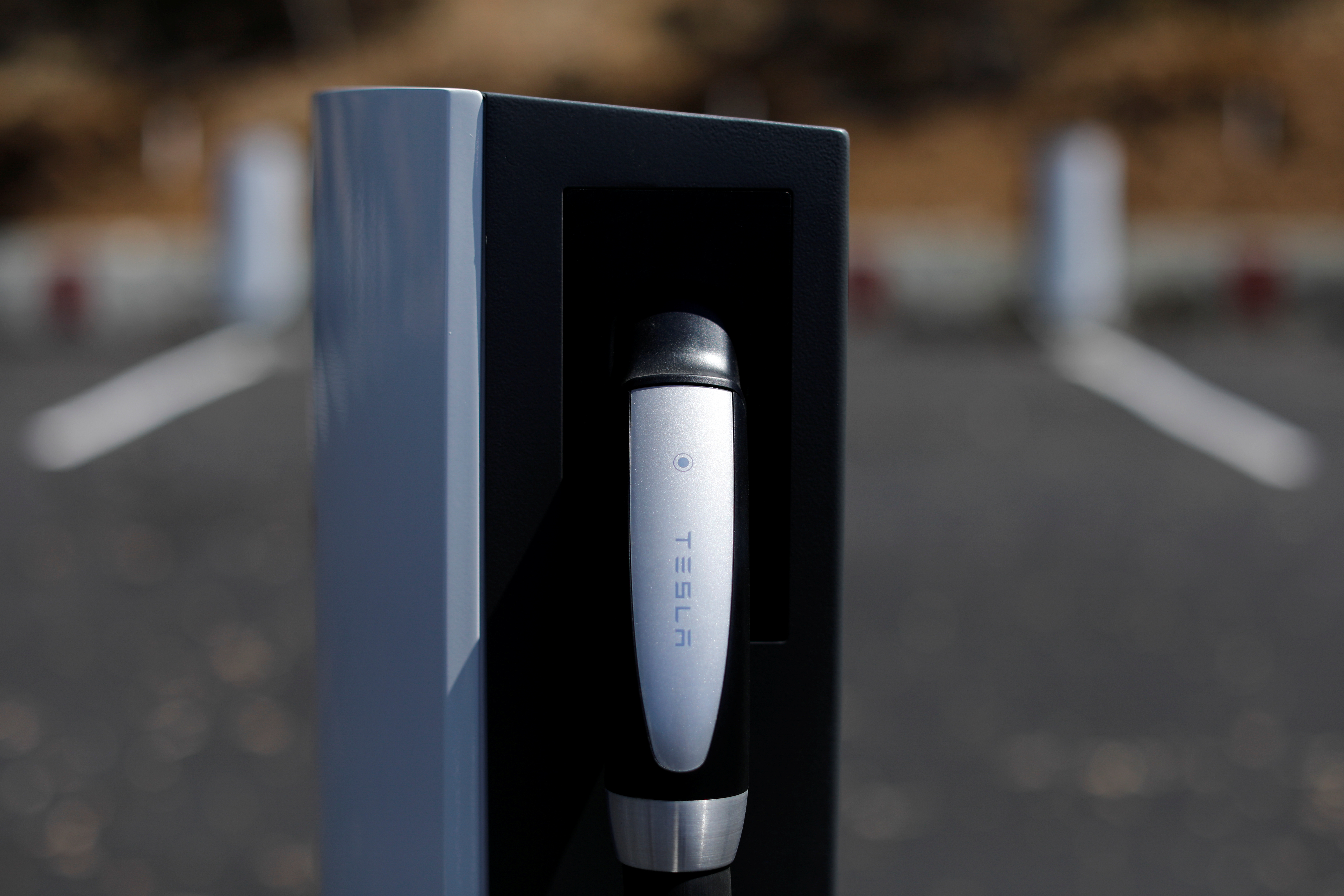 A newly installed car charger at a Tesla Super Charging station is shown in Carlsbad, California