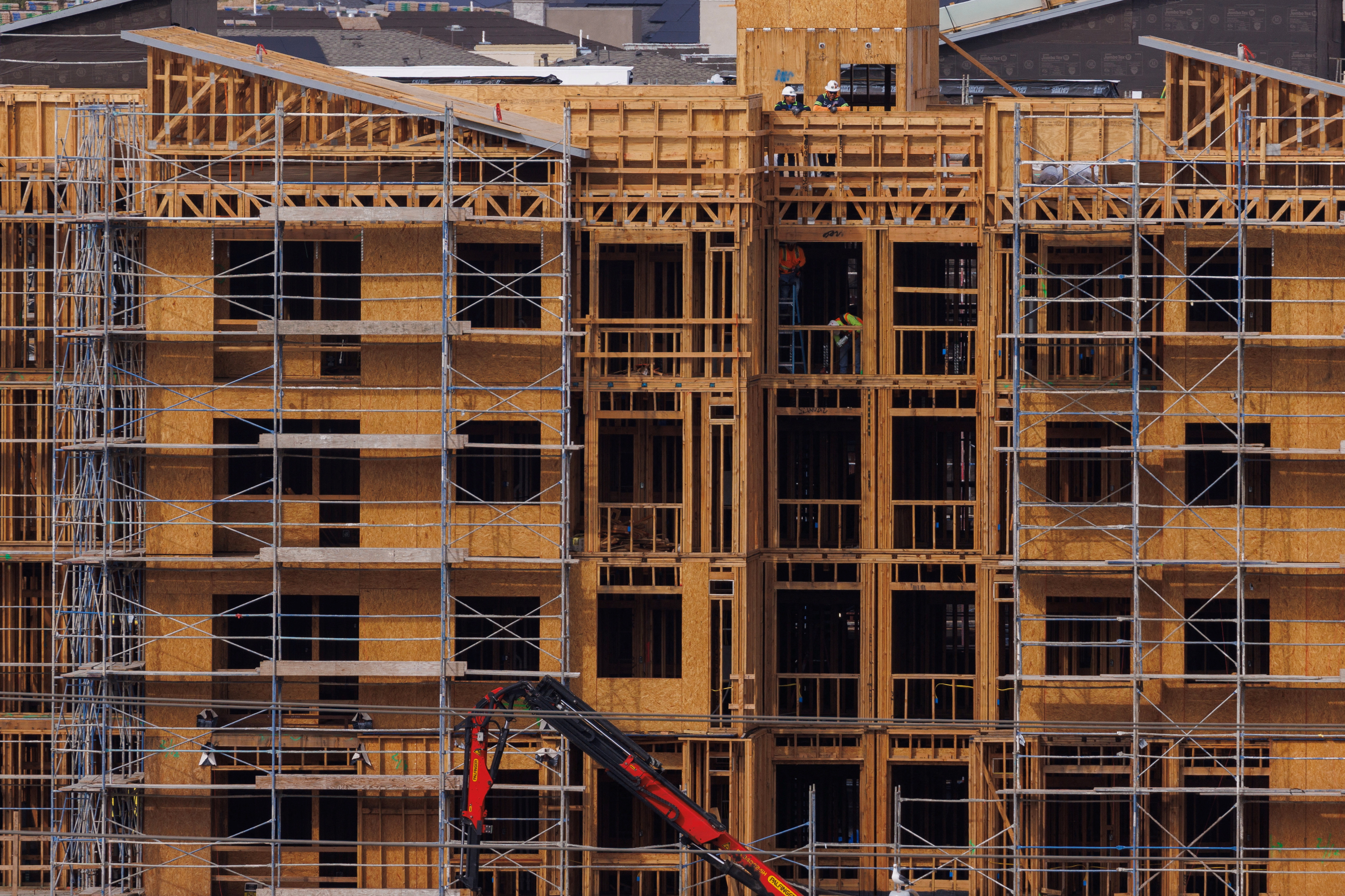 Construction workers build multifamily housing in California