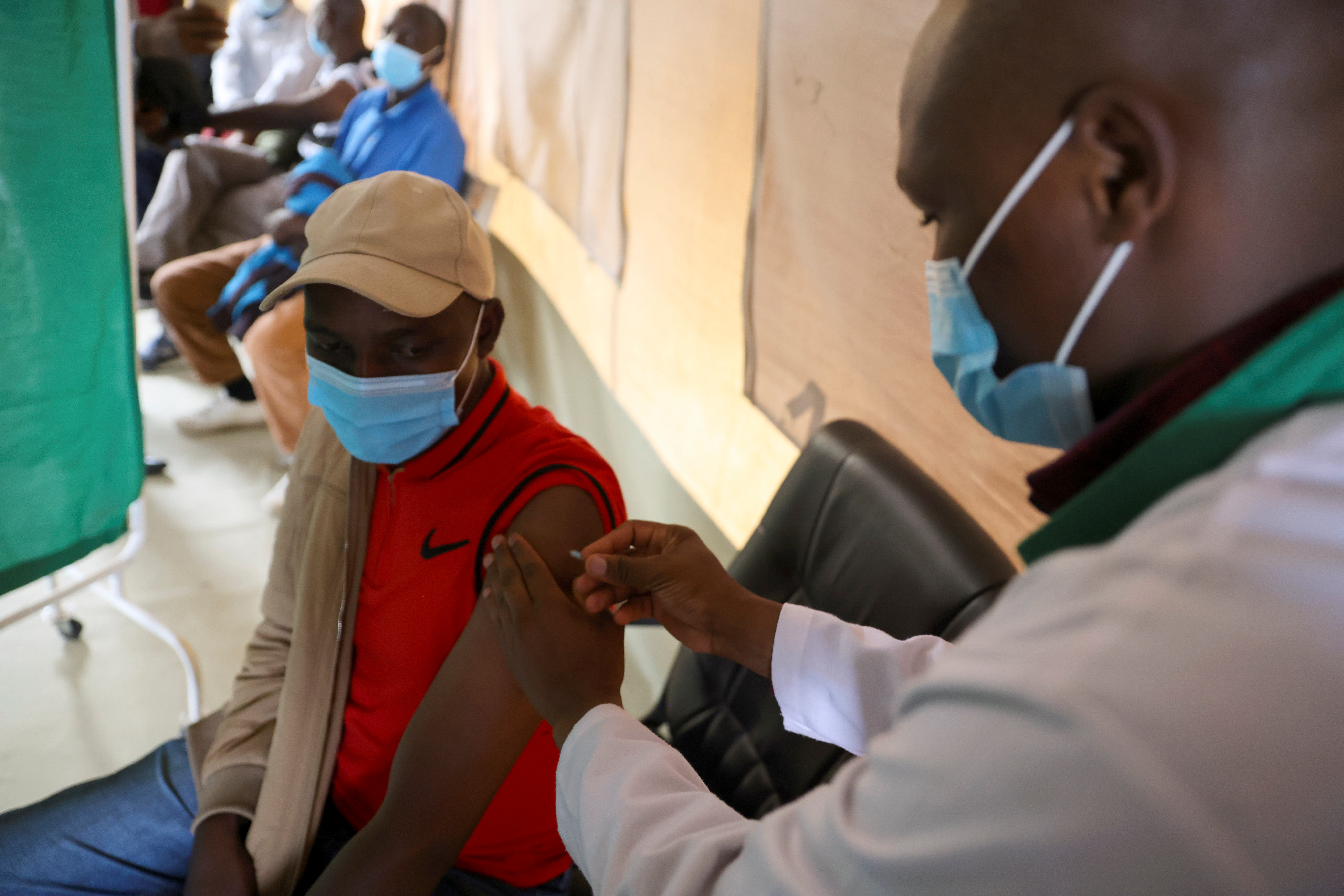 Healthcare professional administers a dose of coronavirus disease (COVID-19) AstraZeneca's vaccine, in Narok