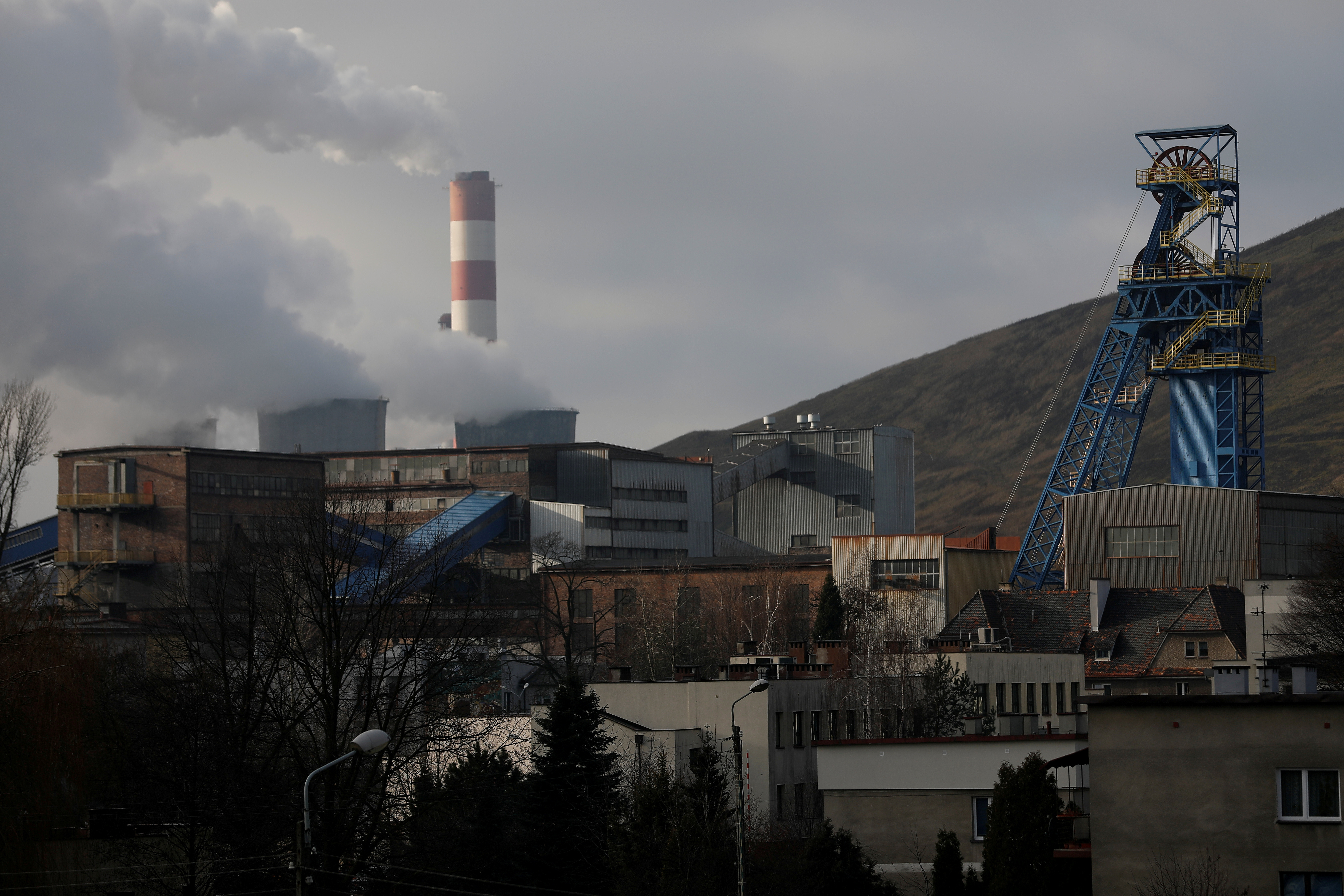 Chimney of Laziska Power Station, a thermal power plant, is seen behind Boleslaw Smialy Coal Mine in Laziska Gorne