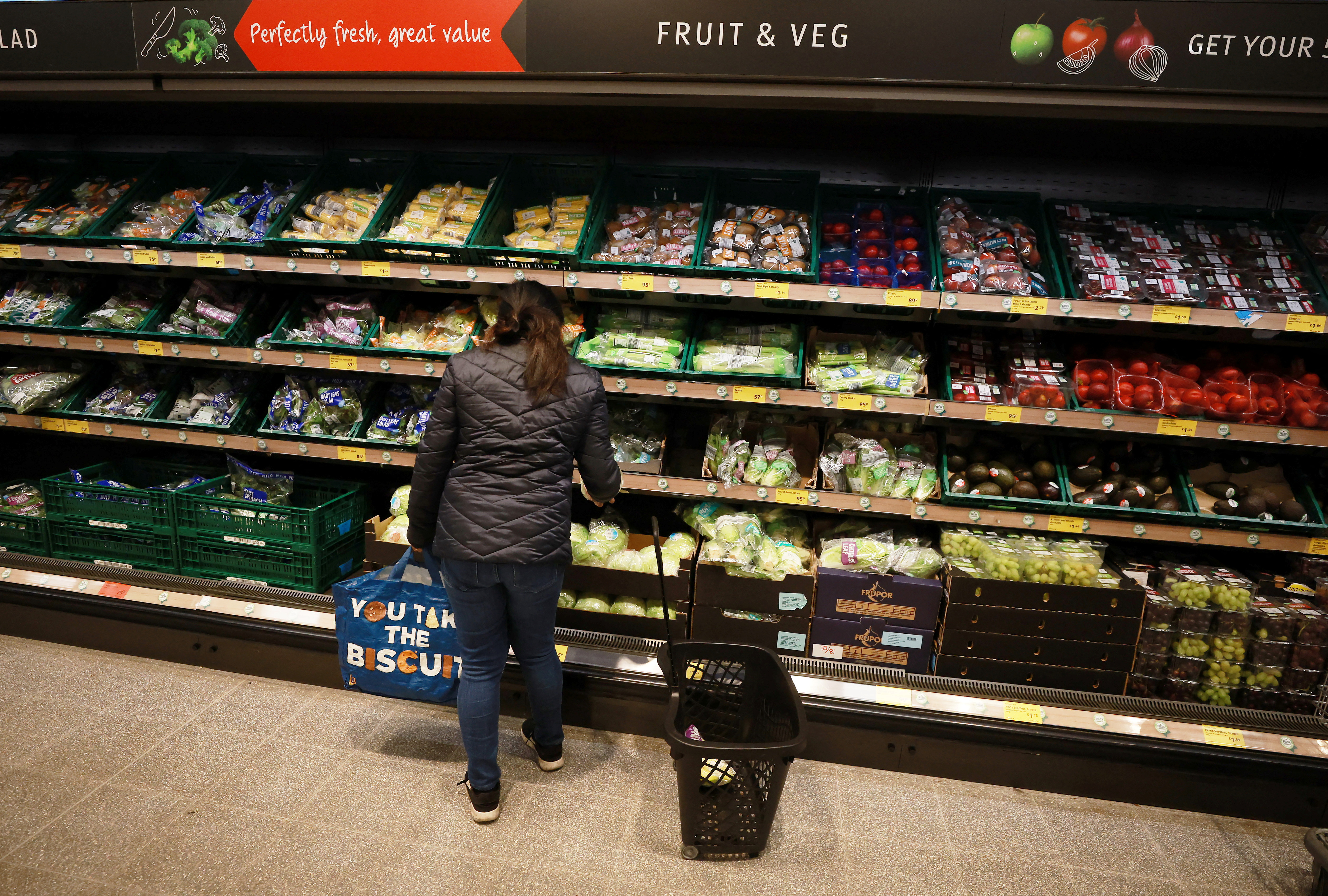 Shopper looks at fruit and vegetables inside an ALDI supermarket near Altrincham