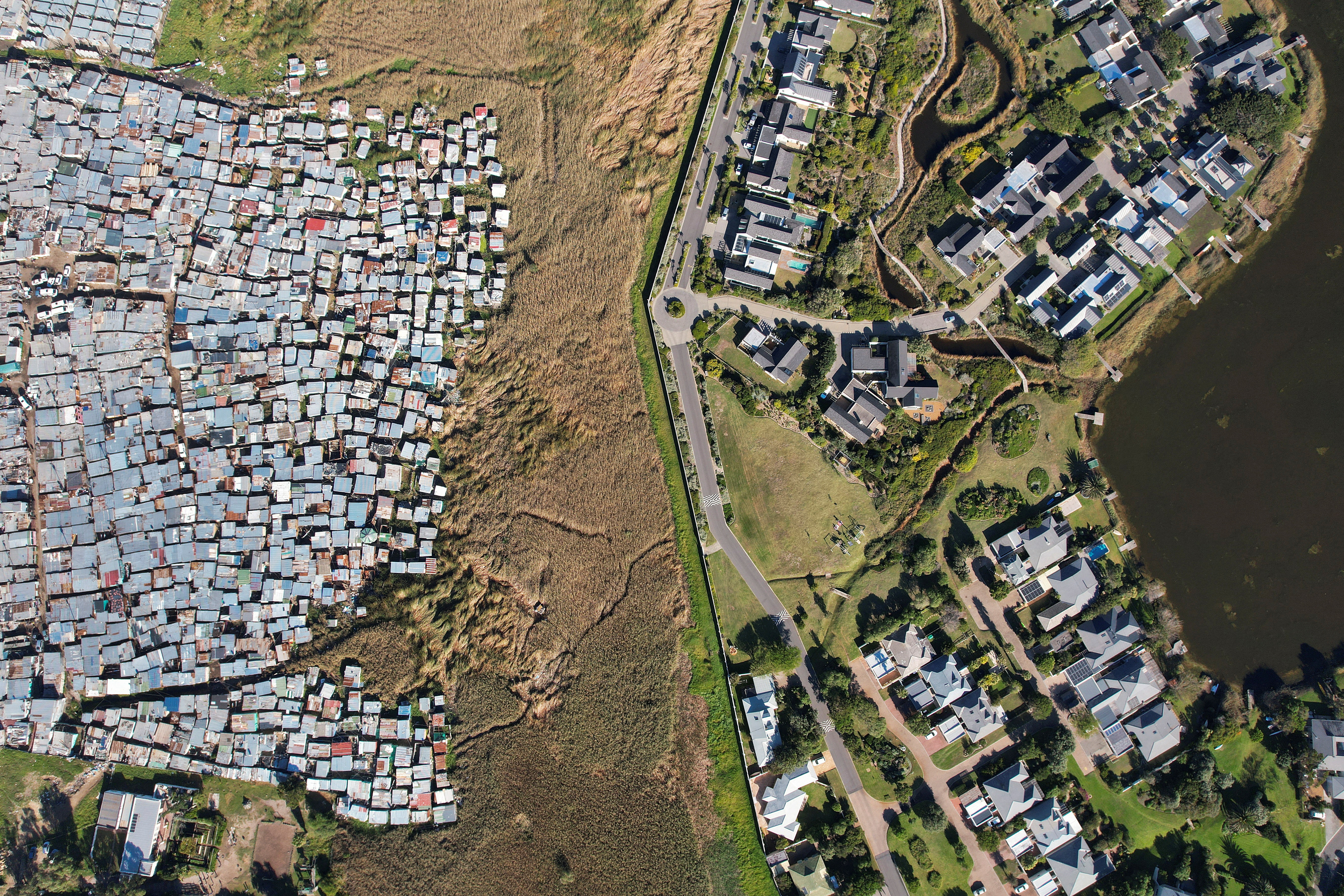 A drone Thirty years after the end of apartheid, equality eludes South Africaview shows informal shacks of the high-density suburb of Masiphumelele, in Cape Town
