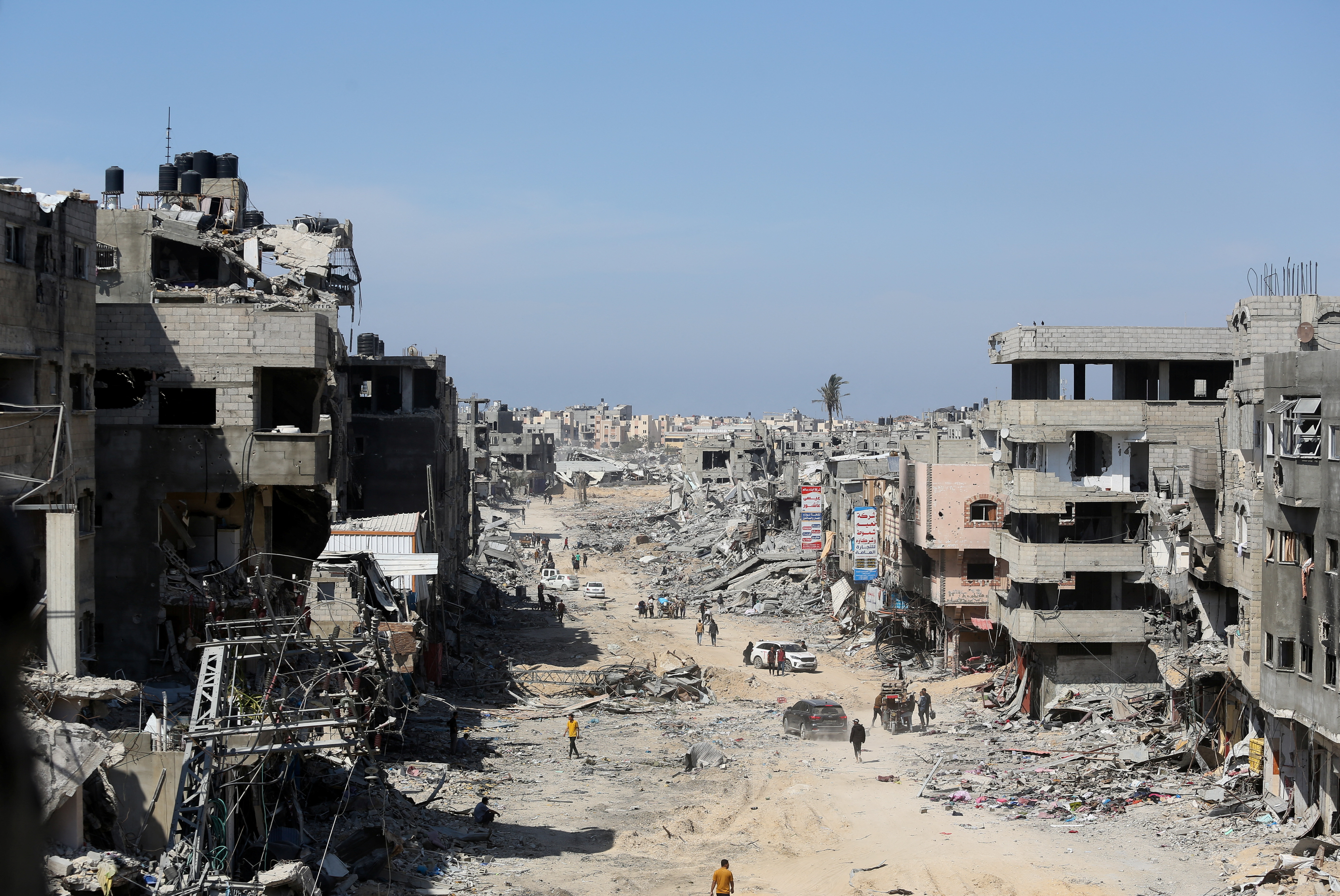 Palestinians inspect destroyed residential buildings in Khan Younis