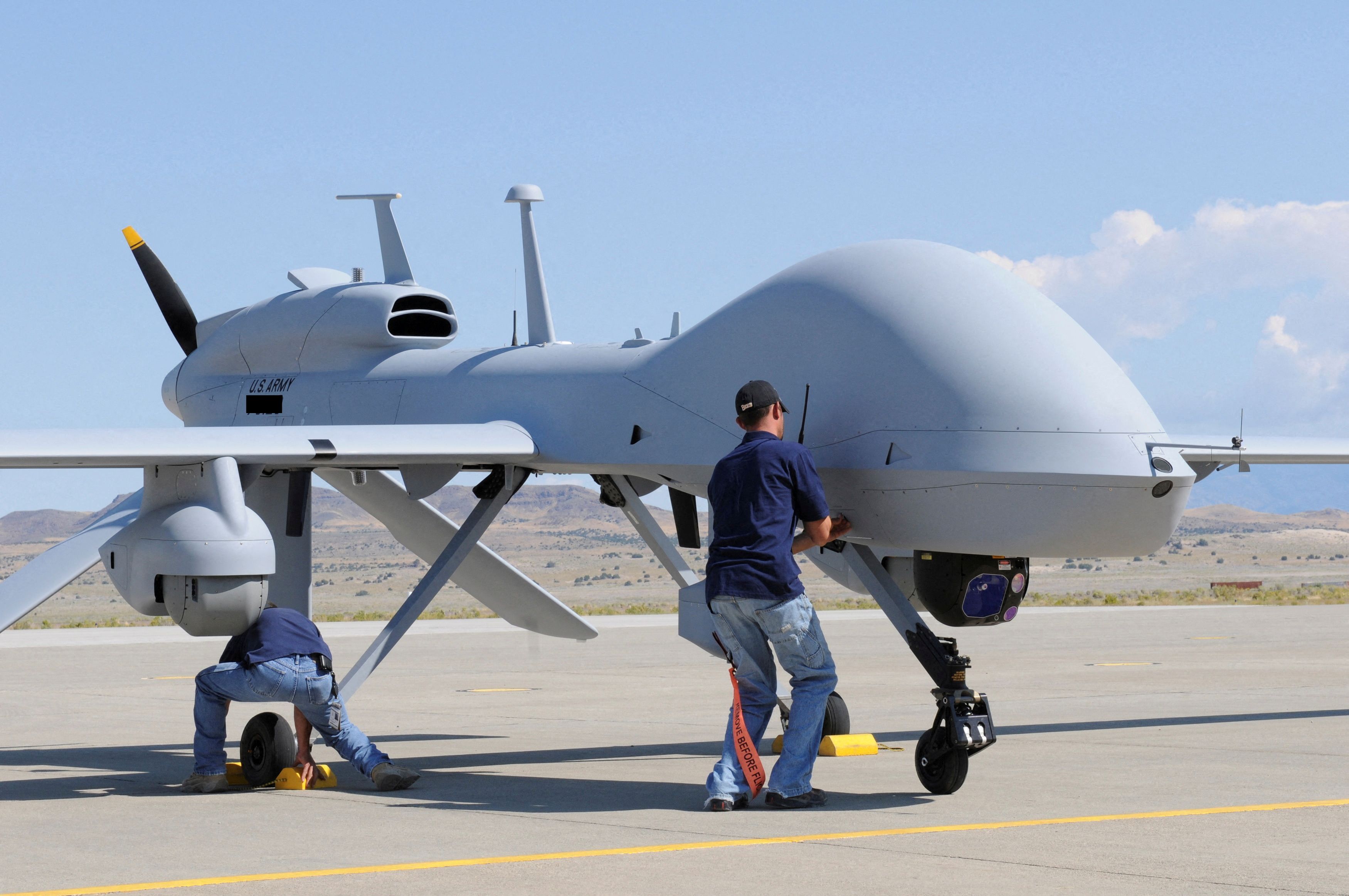 Workers prepare an MQ-1C Gray Eagle unmanned aerial vehicle for static display at Michael Army Airfield, Dugway Proving Ground in Utah in this US Army handout photo