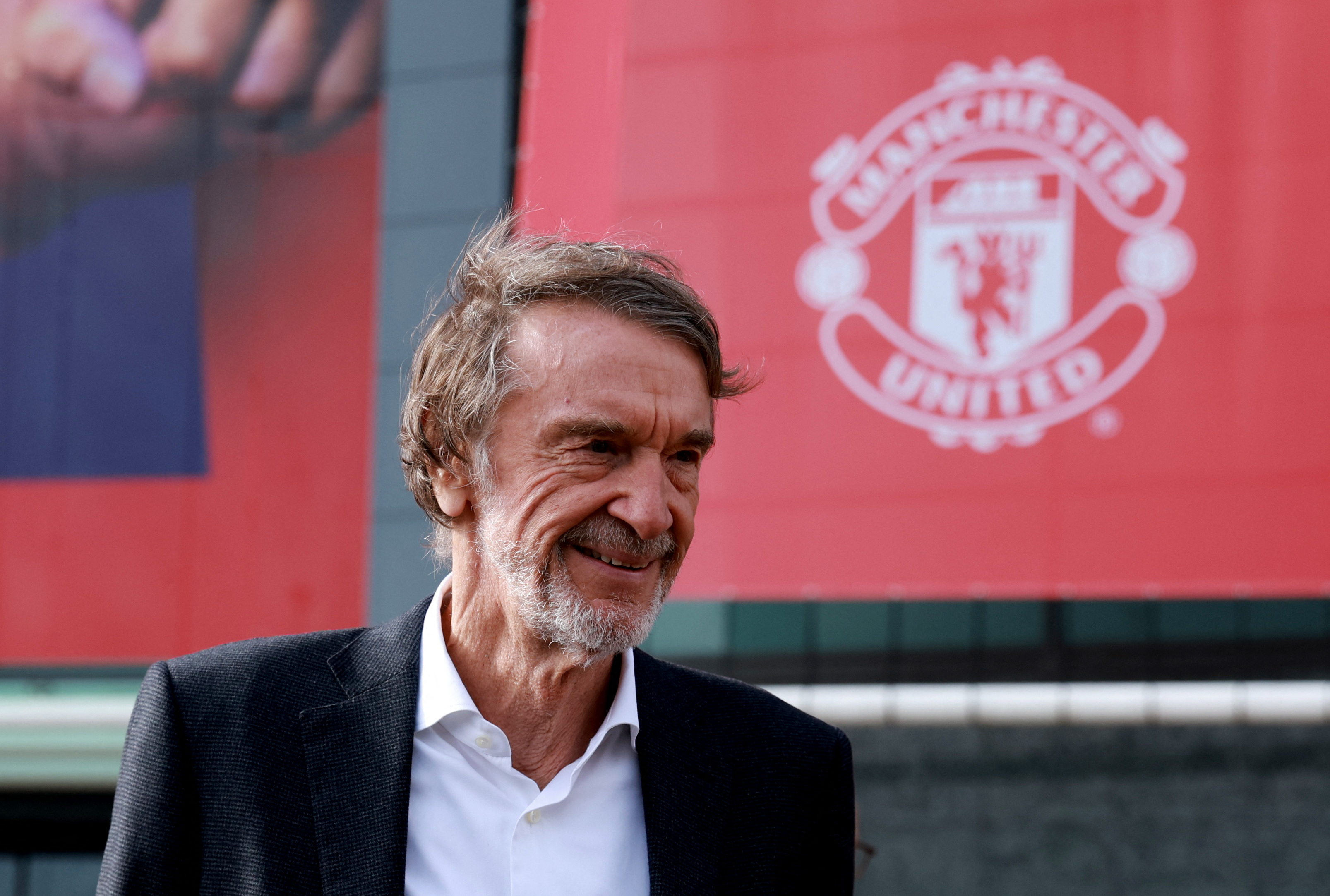  Sir Jim Ratcliffe pictured in front of a Manchester United banner.