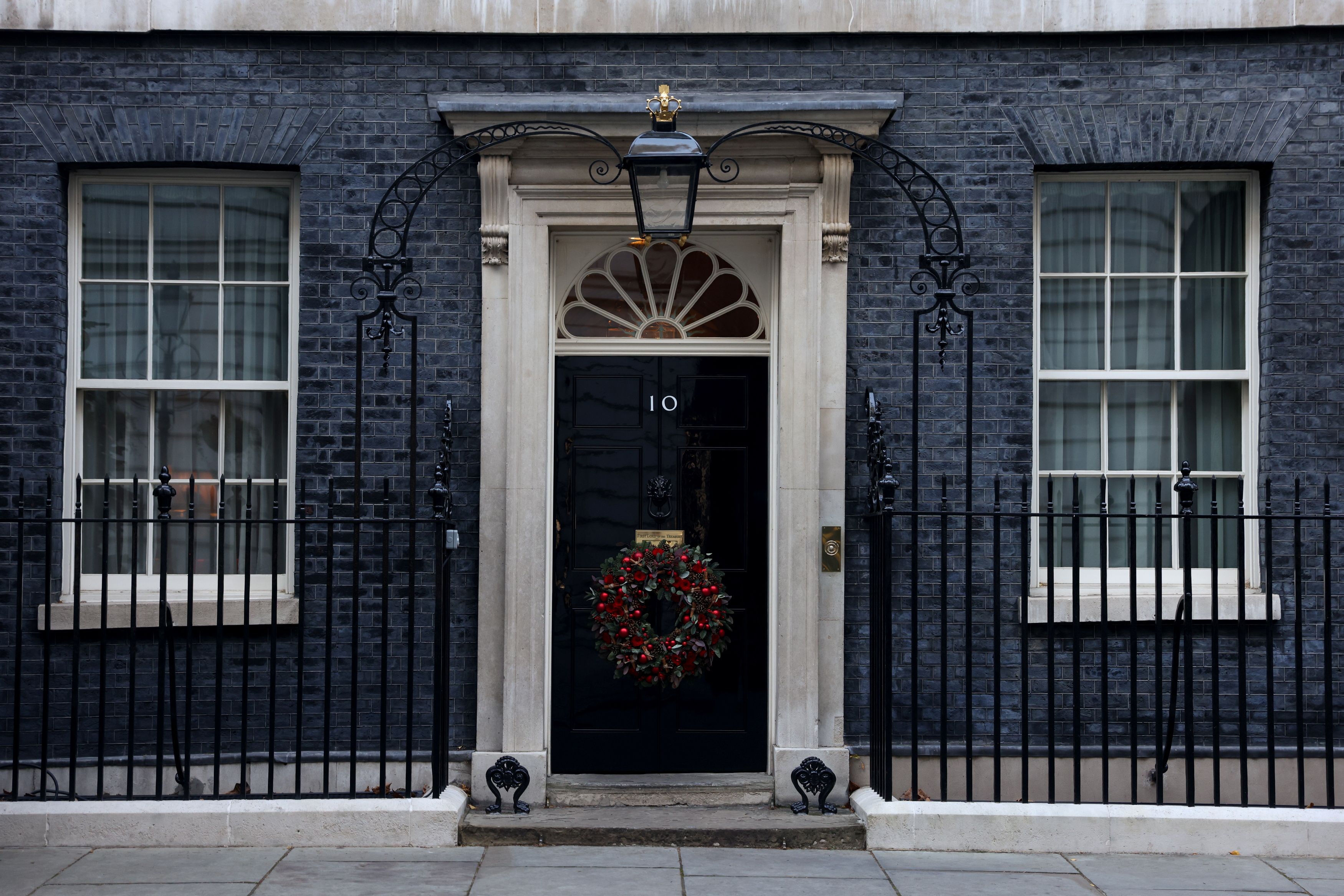 The door of 10 Downing Street is decorated with Christmas decorations in London