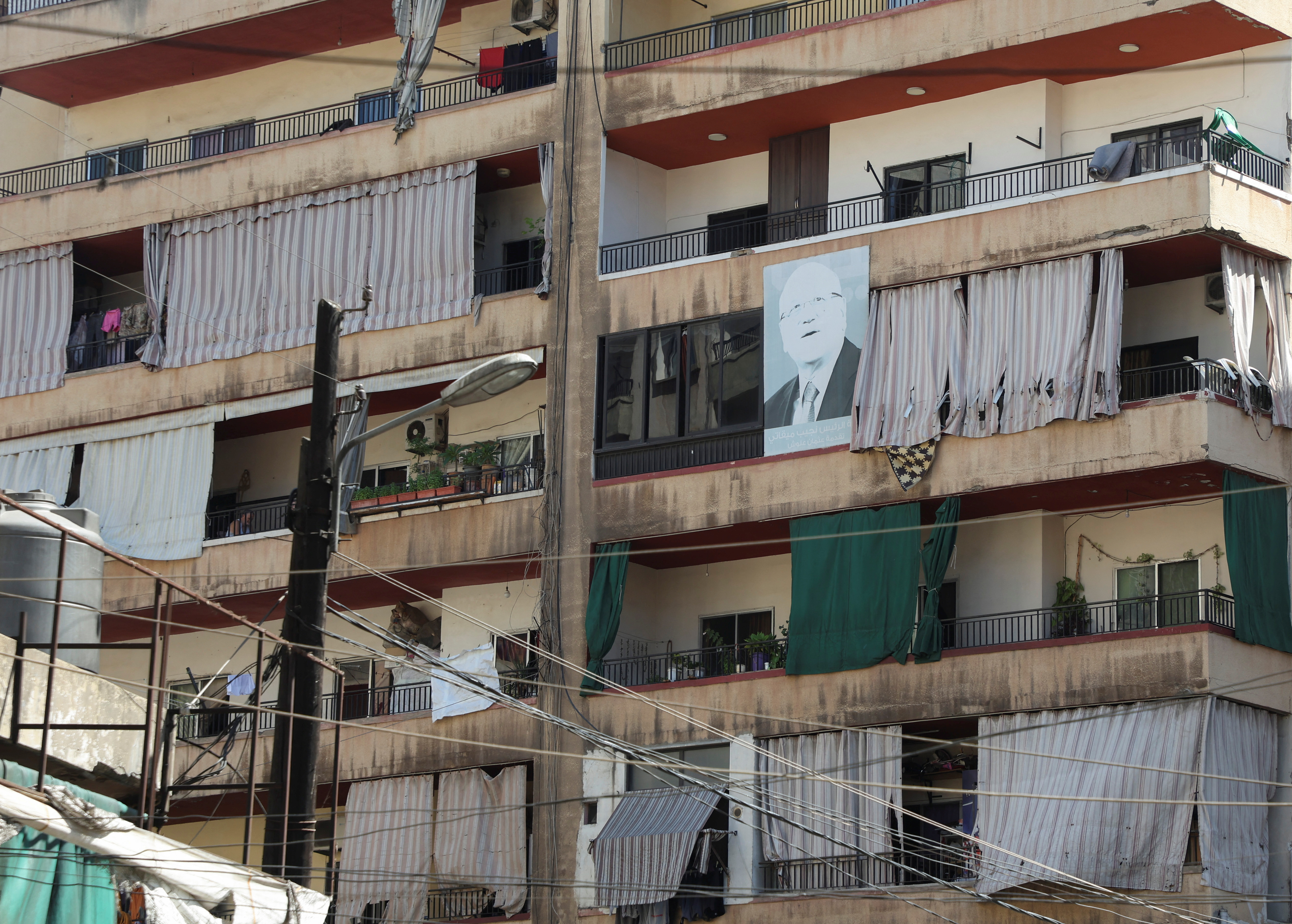 A picture of Lebanon's Prime Minister-designate Najib Mikati is placed on a residential building in the northern city of Tripoli