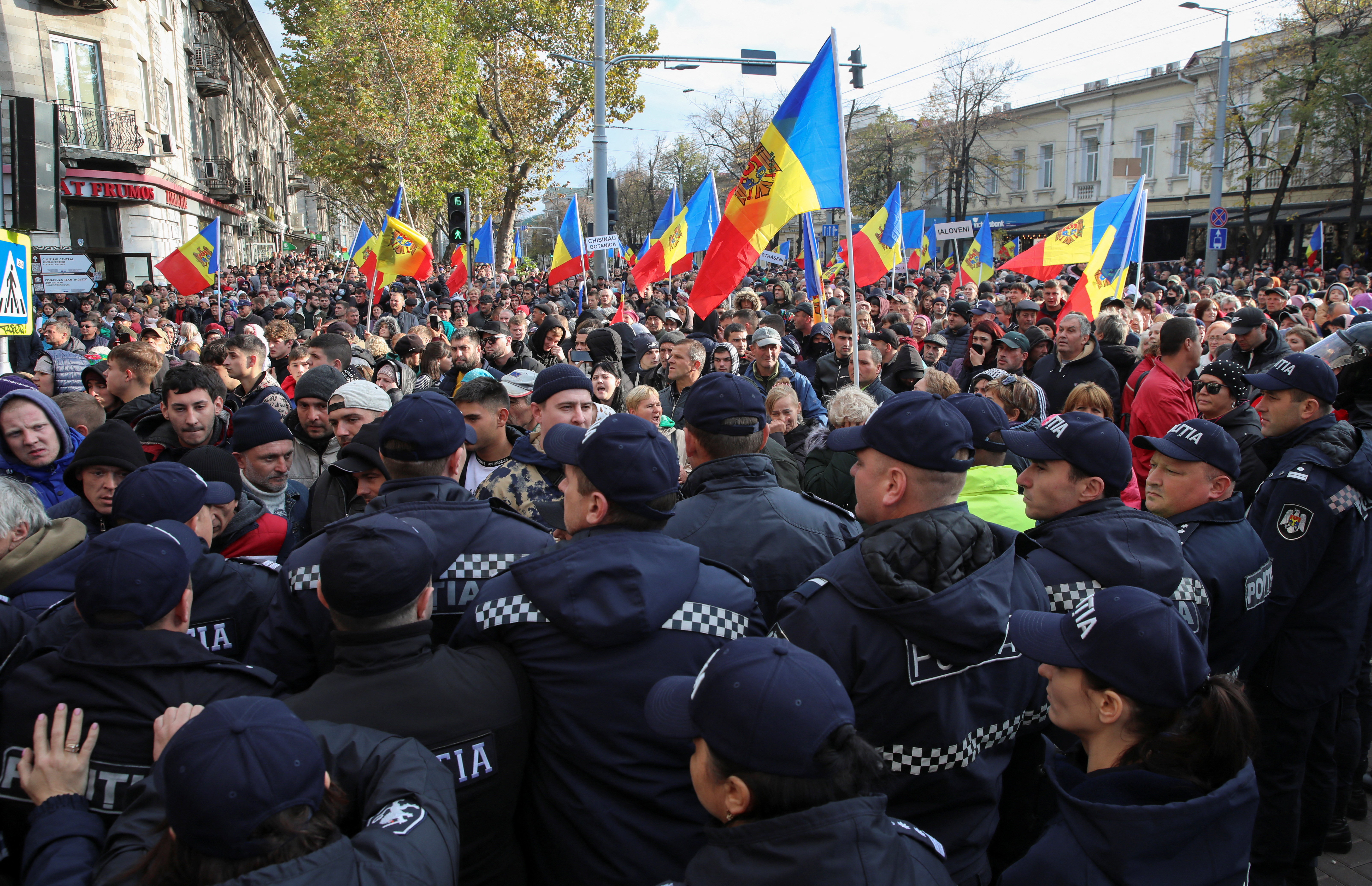 Police officers block a street during an anti-government protest in Chisinau