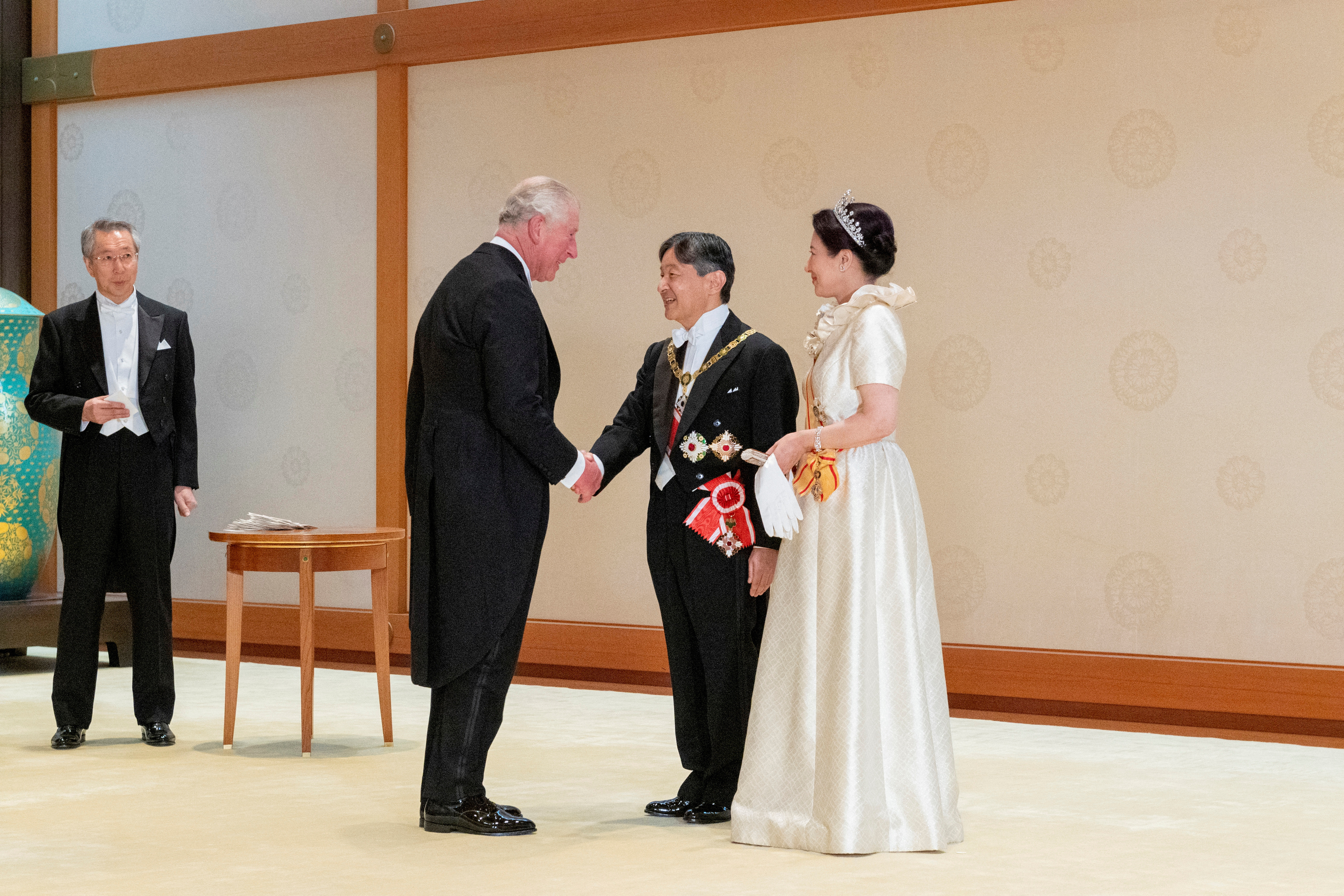 Japan's Emperor Naruhito and Empress Masako welcome Britain's Prince Charles prior to a court banquet at the Imperial Palace in Tokyo