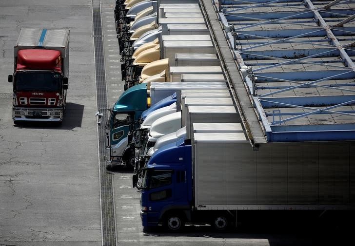 Transportation trucks are parked at a logistic facility in Tokyo