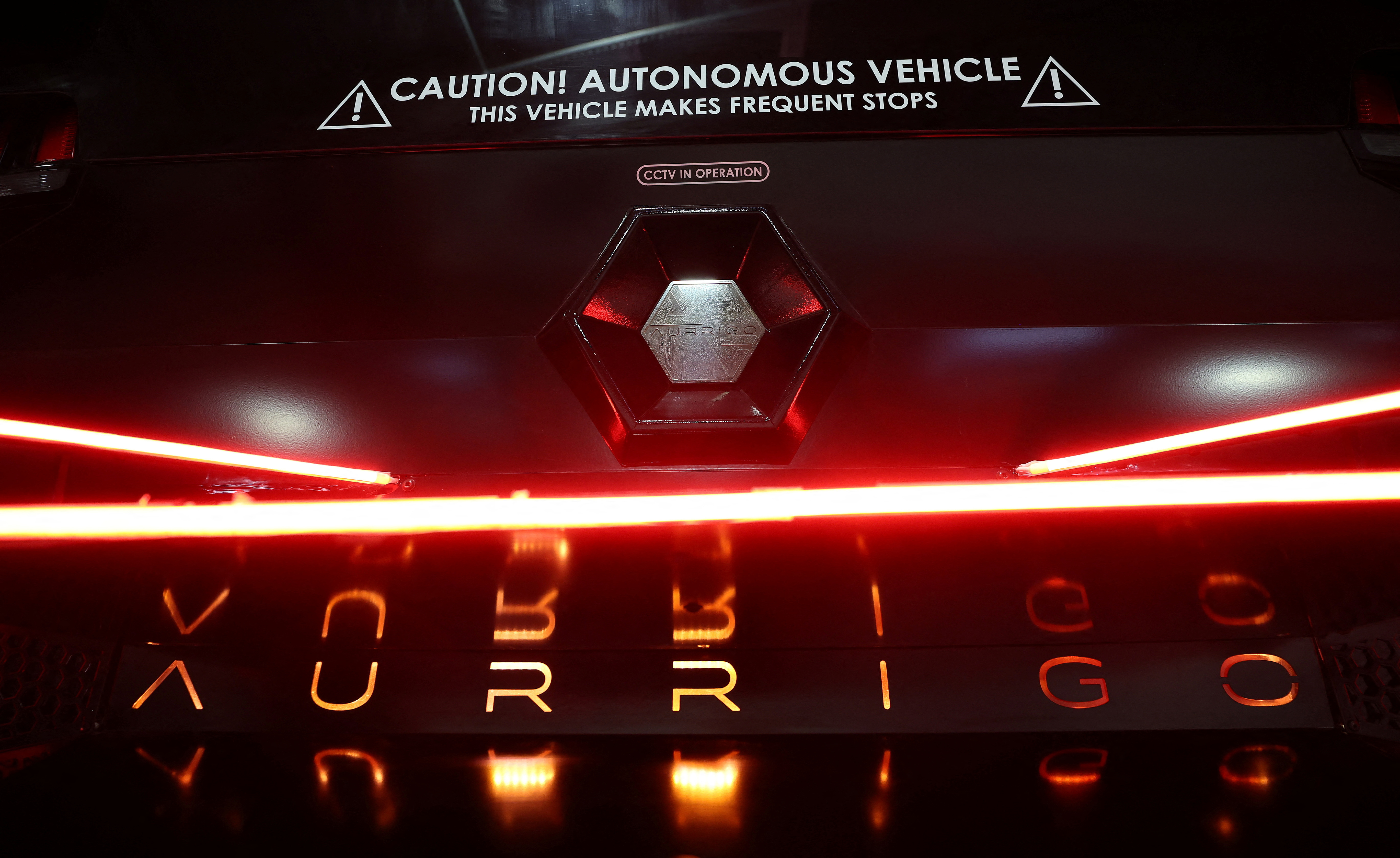 A company logo is seen on the back of an autonomous ‘Auto-Shuttle’ vehicle inside the Aurrigo factory in Coventry