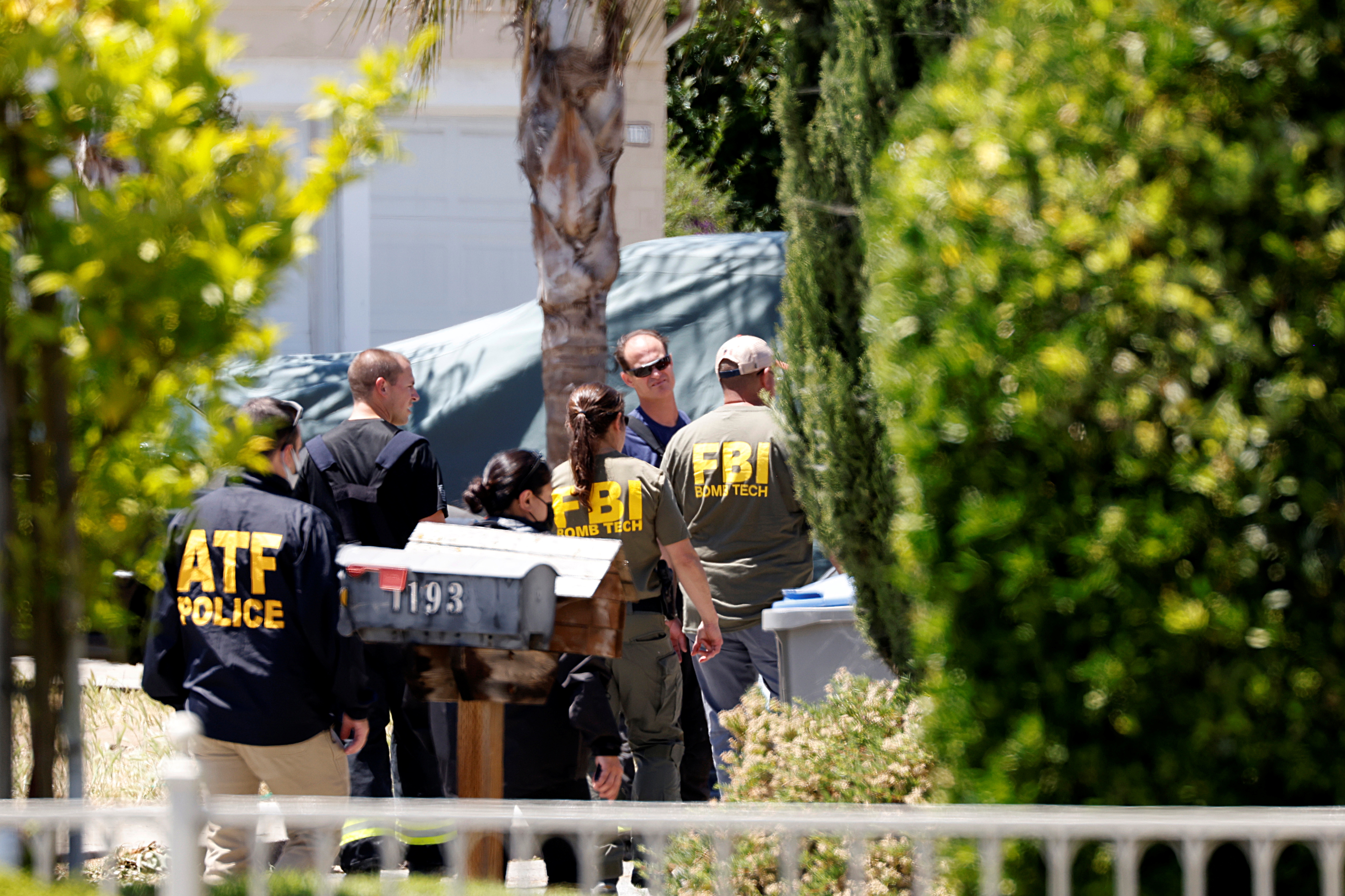 Agents approach the scene of the Santa Clara Valley Transportation Authority mass shooting suspect's house in San Jose