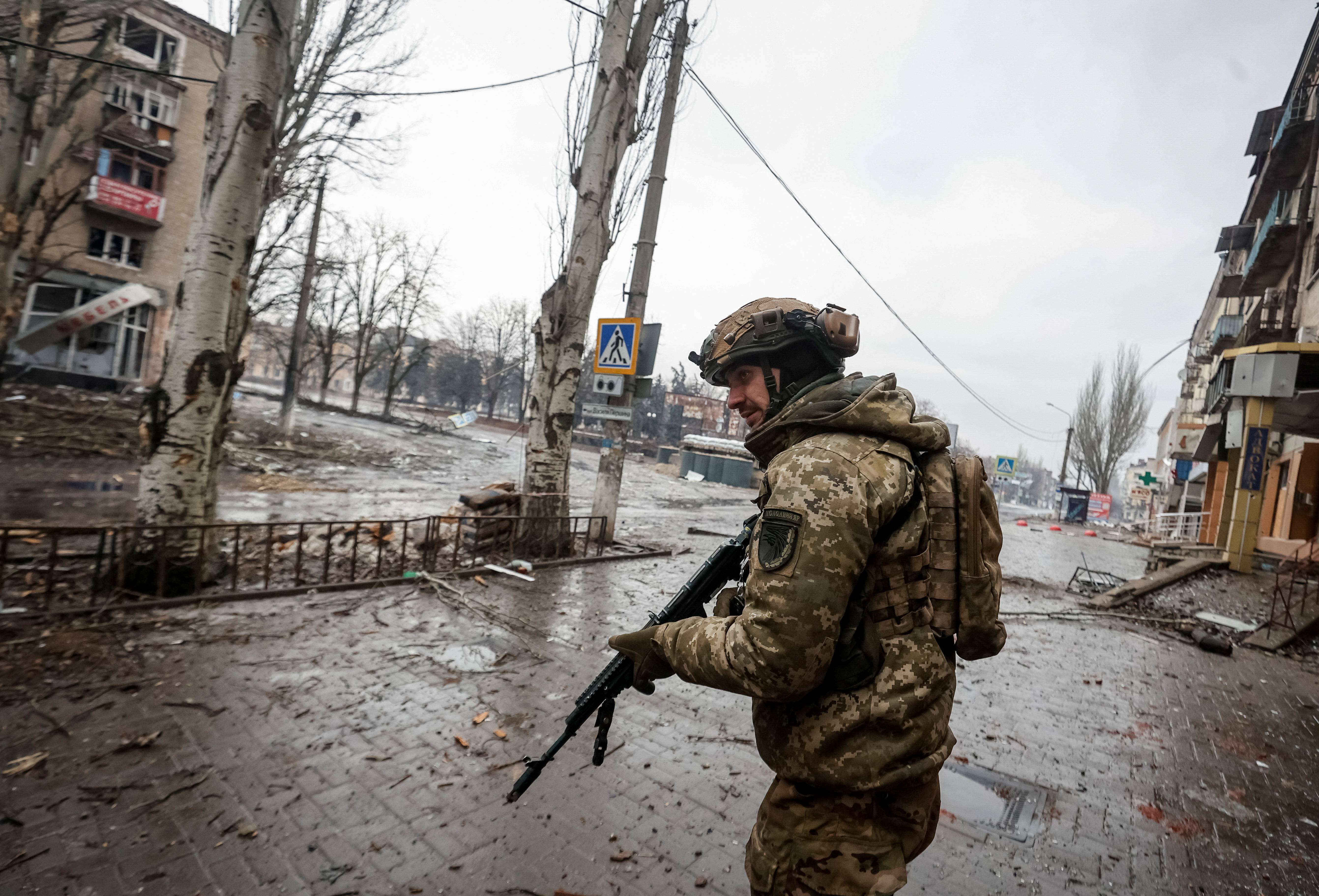 A Ukrainian serviceman walks an empty street in the front line city of Bakhmut