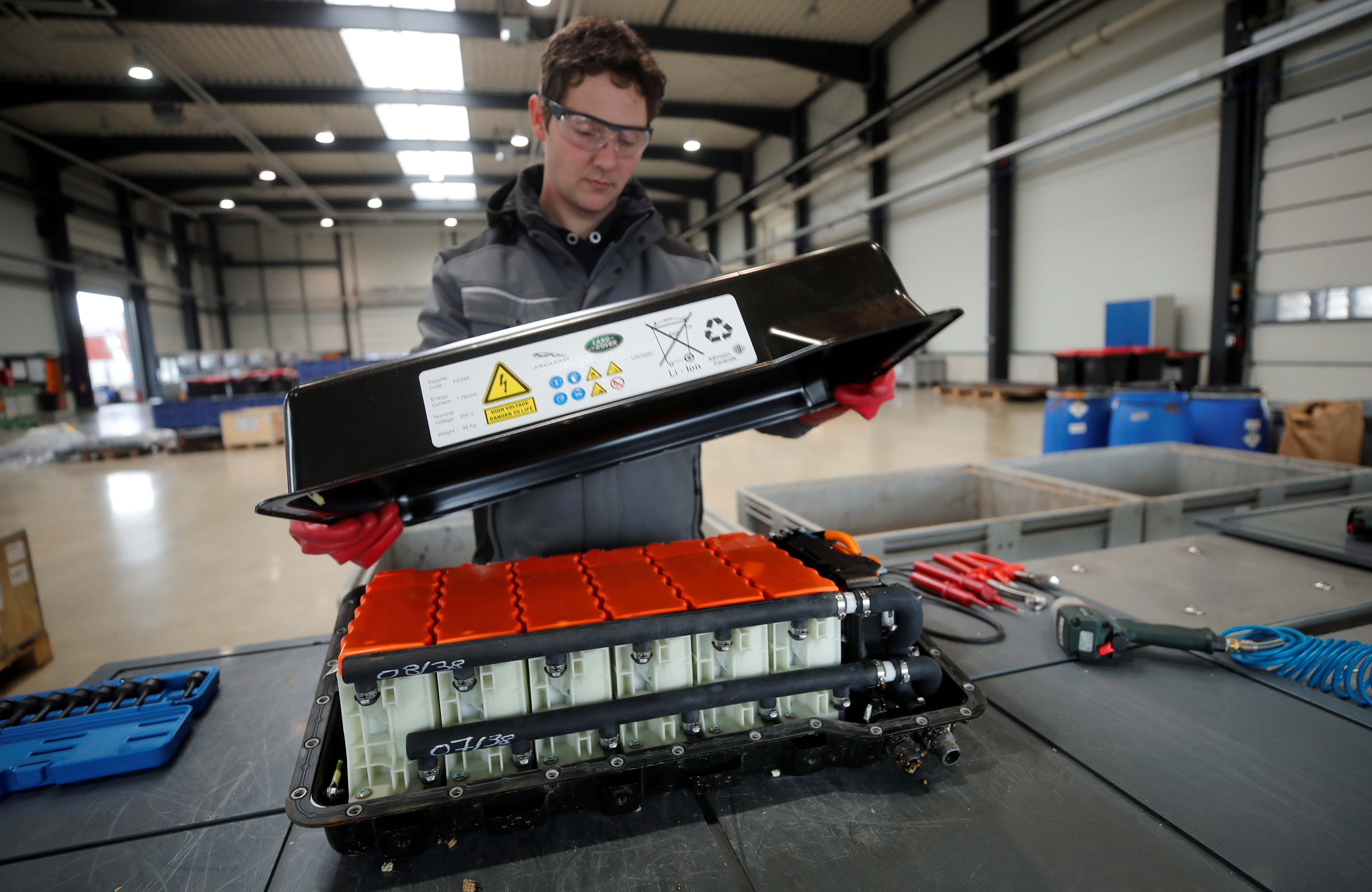 A used Lithium-ion car battery is opened before its dismantling by an employee of the German recycling firm Accurec in Krefeld, Germany, November 16, 2017. REUTERS/Wolfgang Rattay