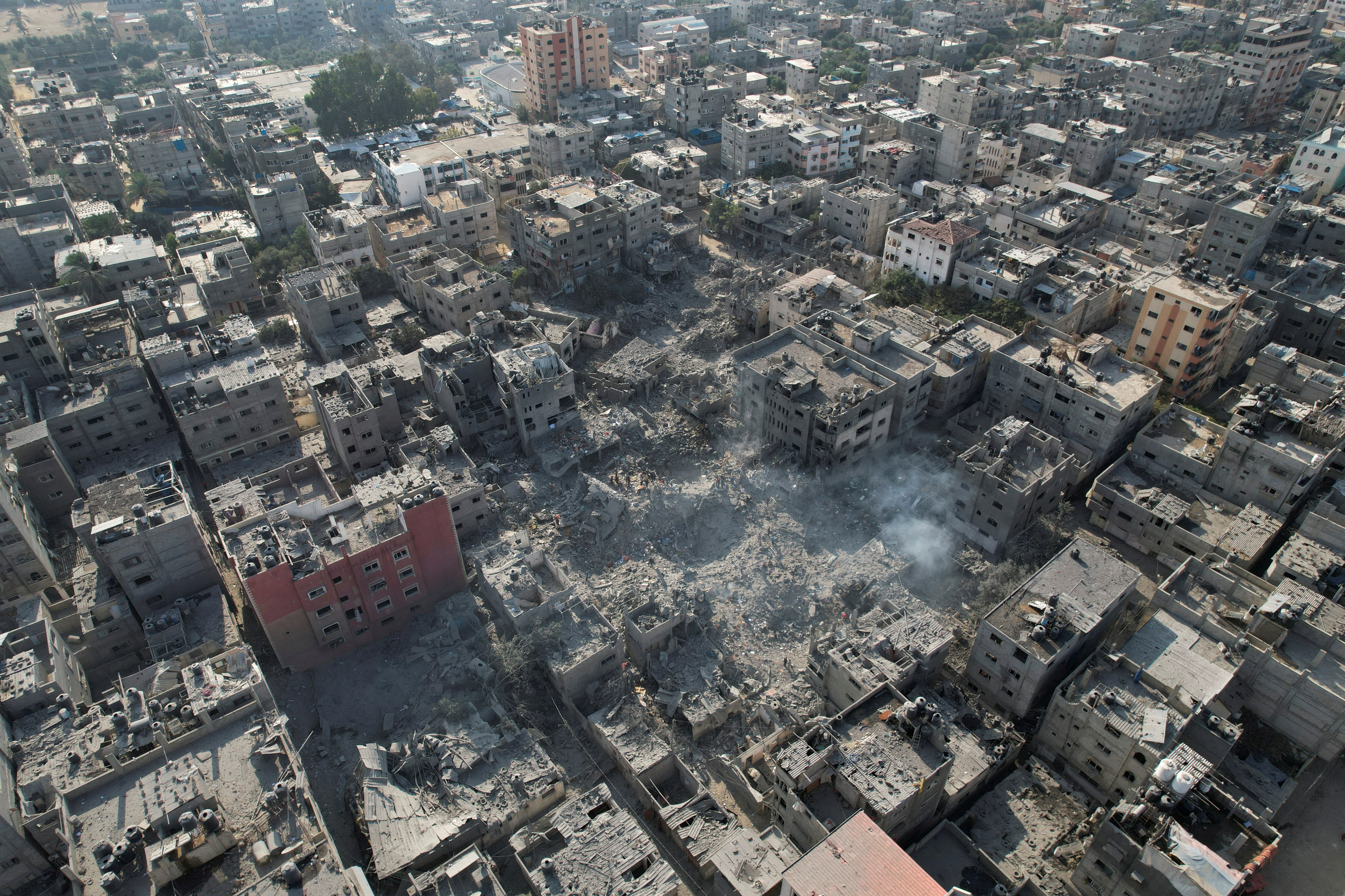 Palestinians gather at the site of an Israeli attack on houses in Breiji, central Gaza Strip