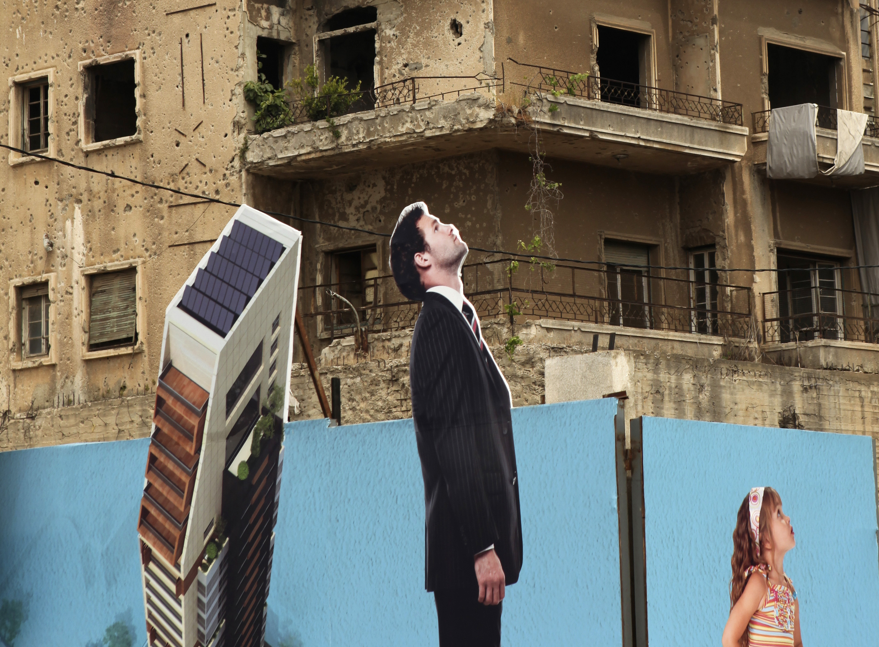A billboard, advertising a luxury residential complex, surrounds a construction site in Beirut