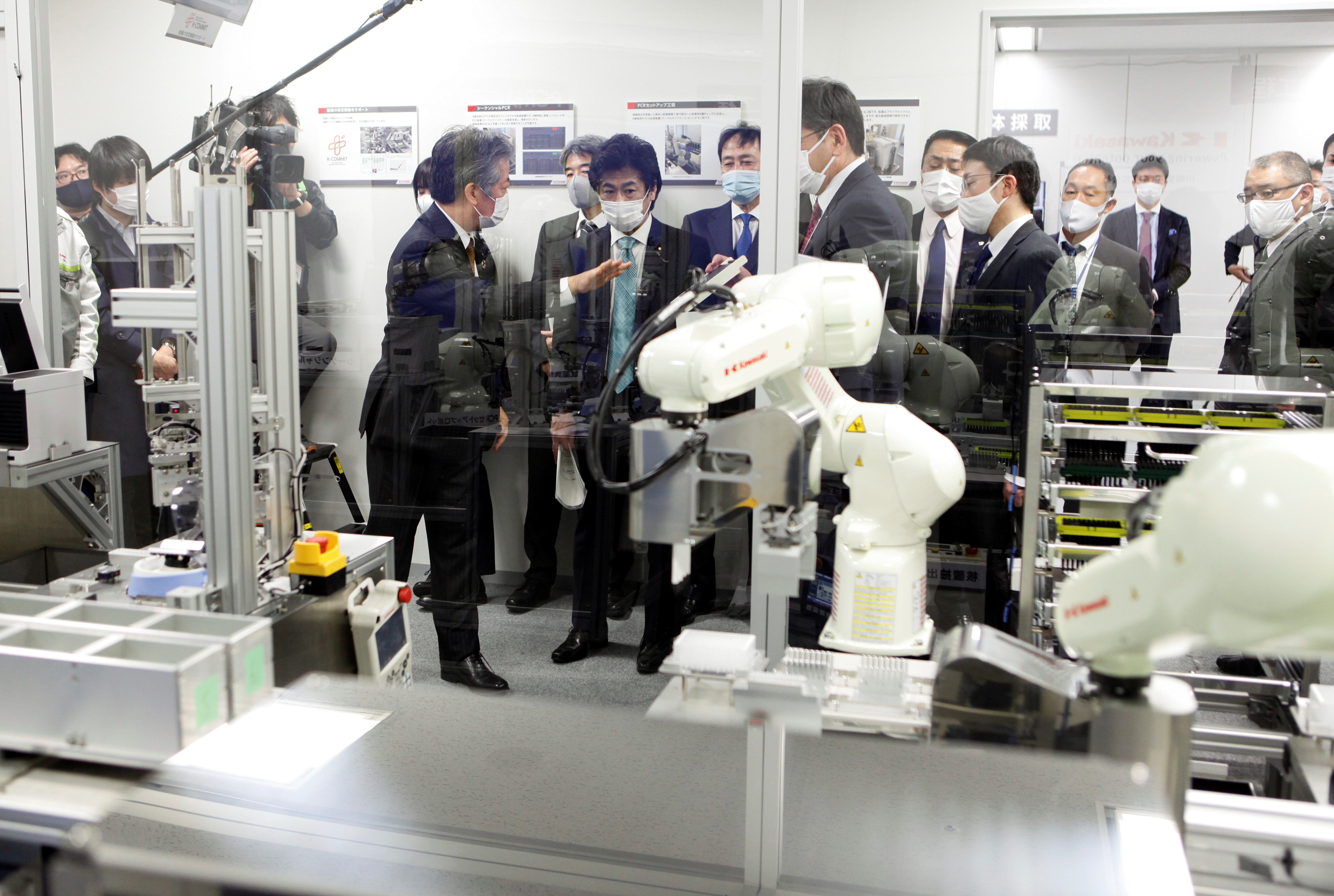 Japan's Health Minister Norihisa Tamura visits the Kawasaki Heavy Industries' Tokyo Robot Centre, a facility that researches polymerase chain reaction (PCR) test automation, amid the coronavirus disease (COVID-19) pandemic, in Tokyo, Japan January 19, 2021. REUTERS/Akira Tomoshige