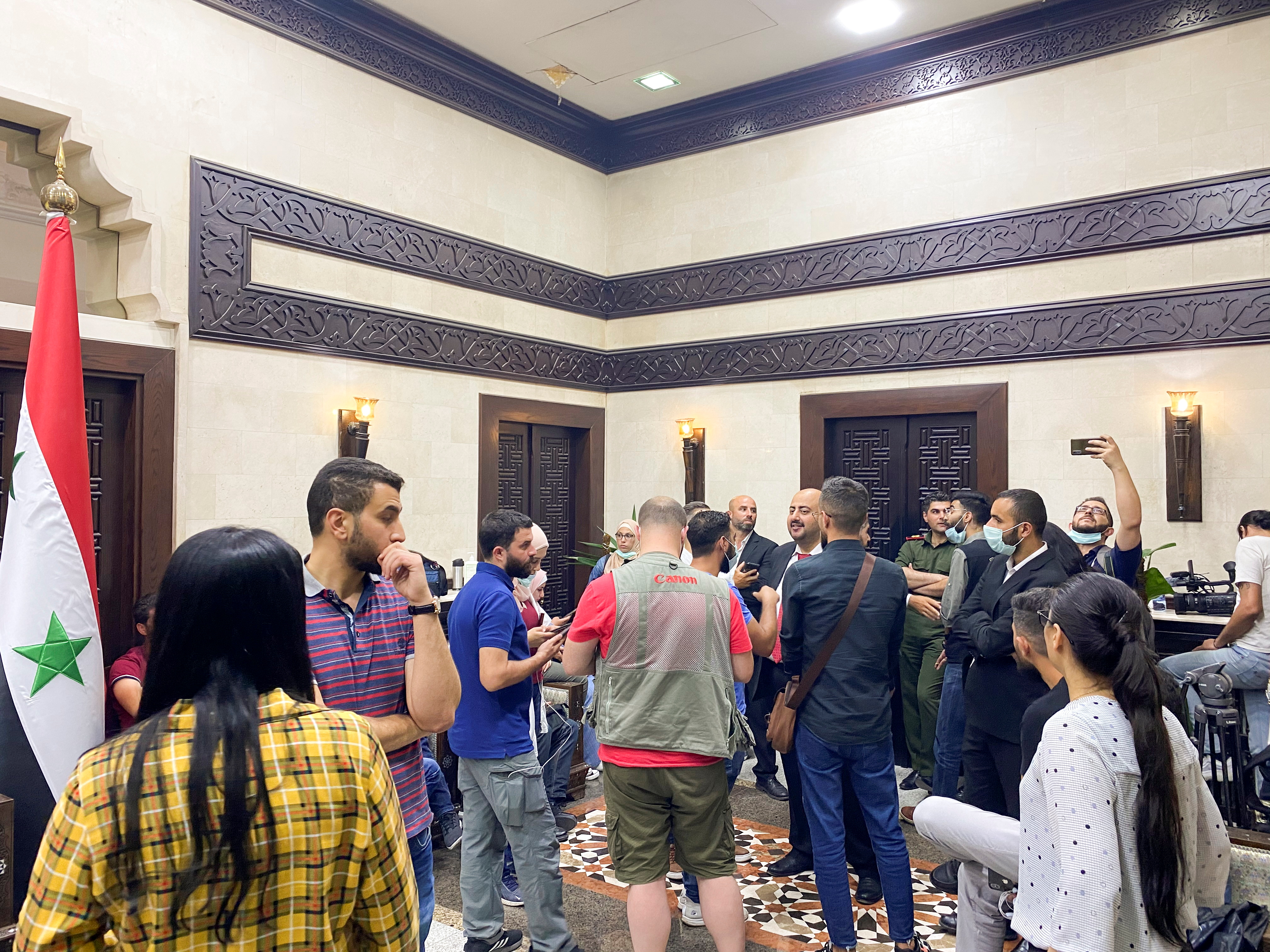 Journalists wait in a hall before the announcement of the Syrian presidential election results, at the Syrian parliament building in Damascus