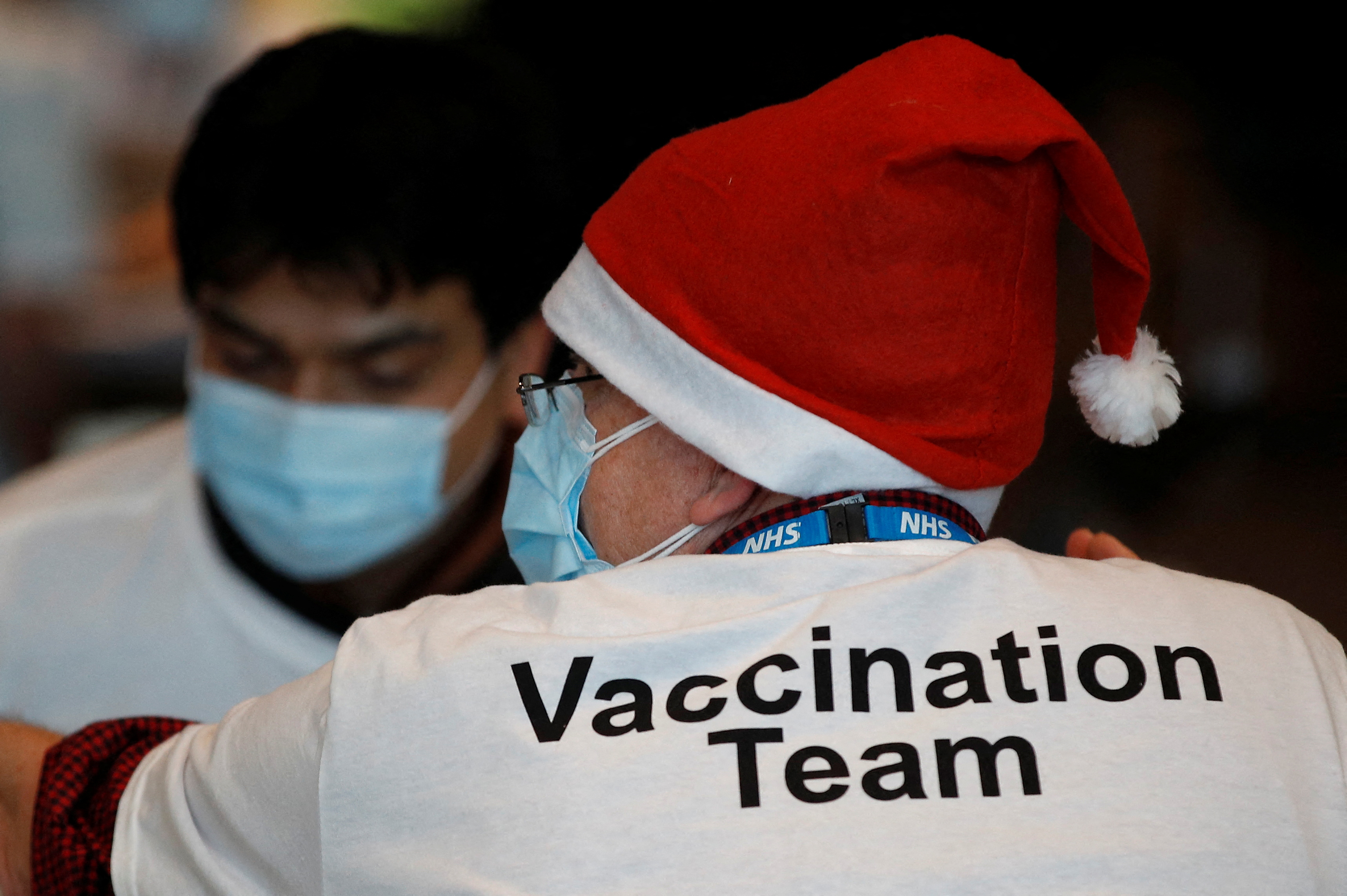 A healthcare professional wears a Santa Claus hat at a coronavirus disease (COVID-19) pop-up vaccination centre at Wembley Stadium in London
