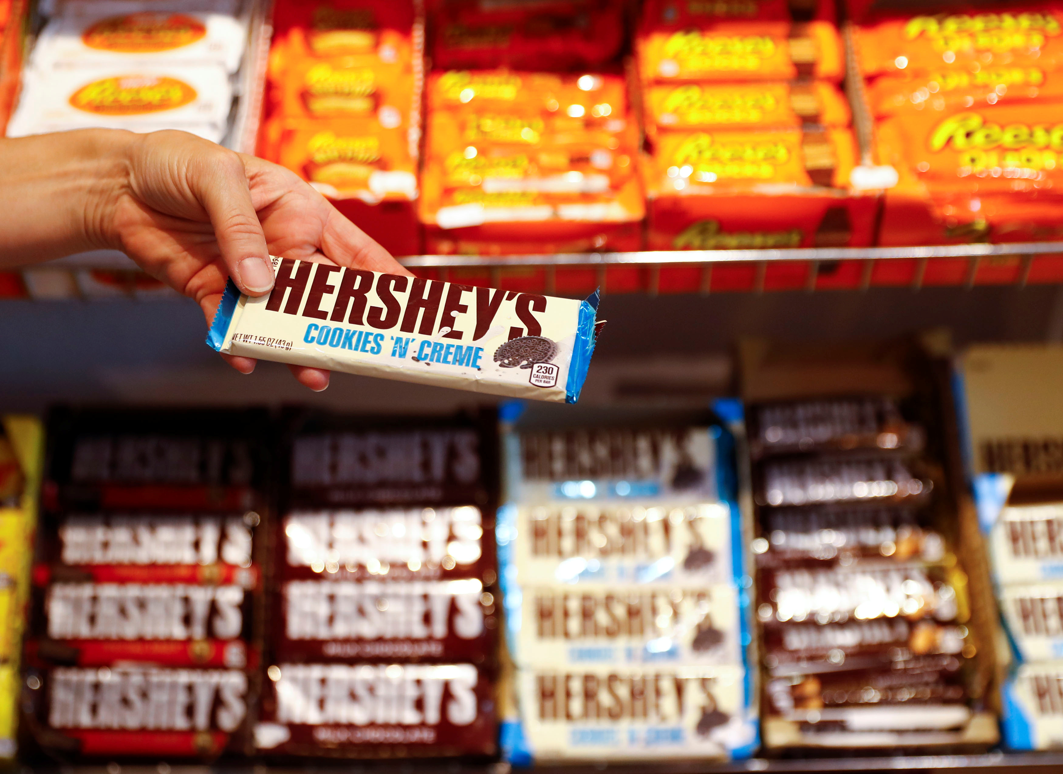 An employee shows a Hershey's chocolate bar made in USA in the 