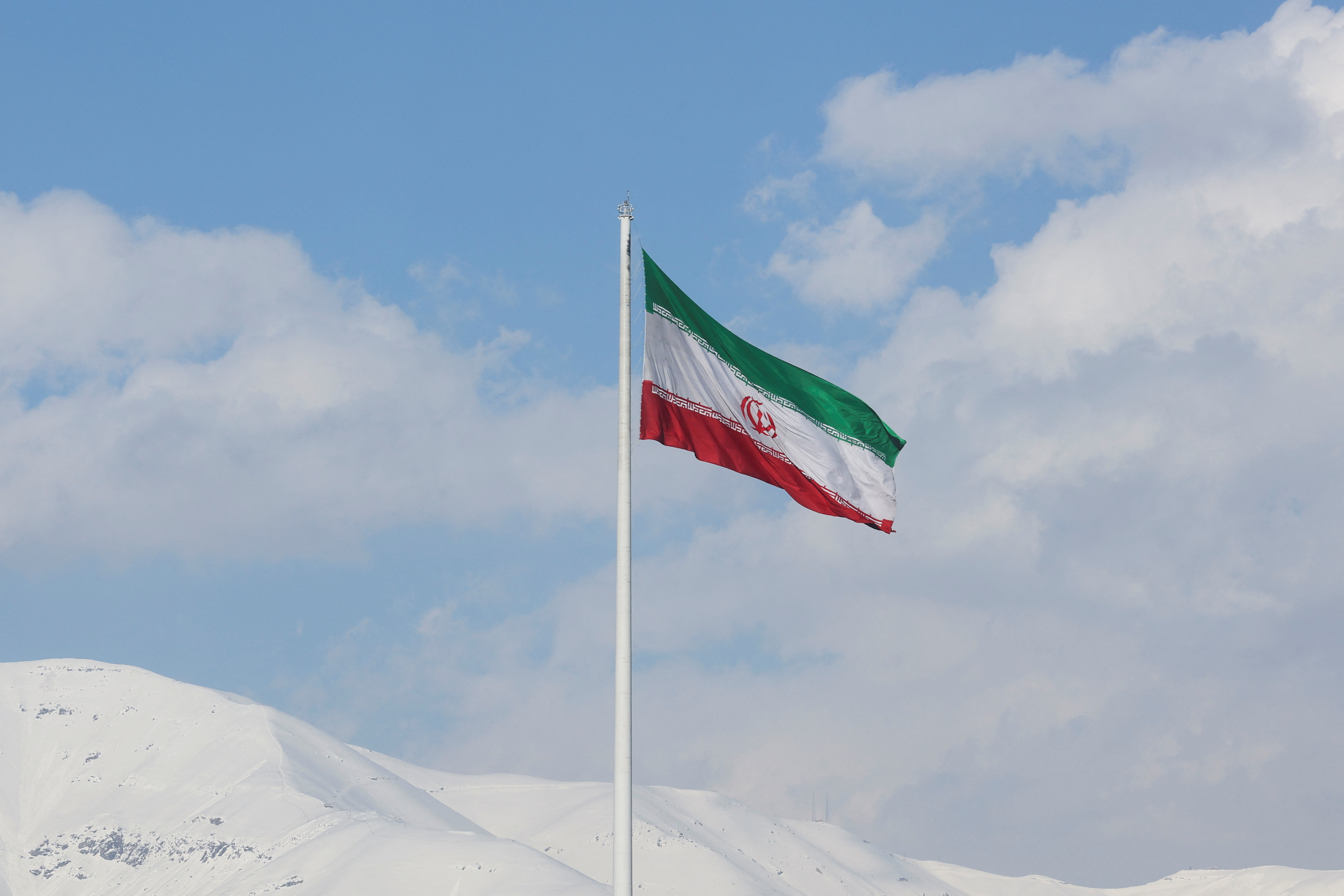 The Iranian flag is seen flying over a street in Tehran