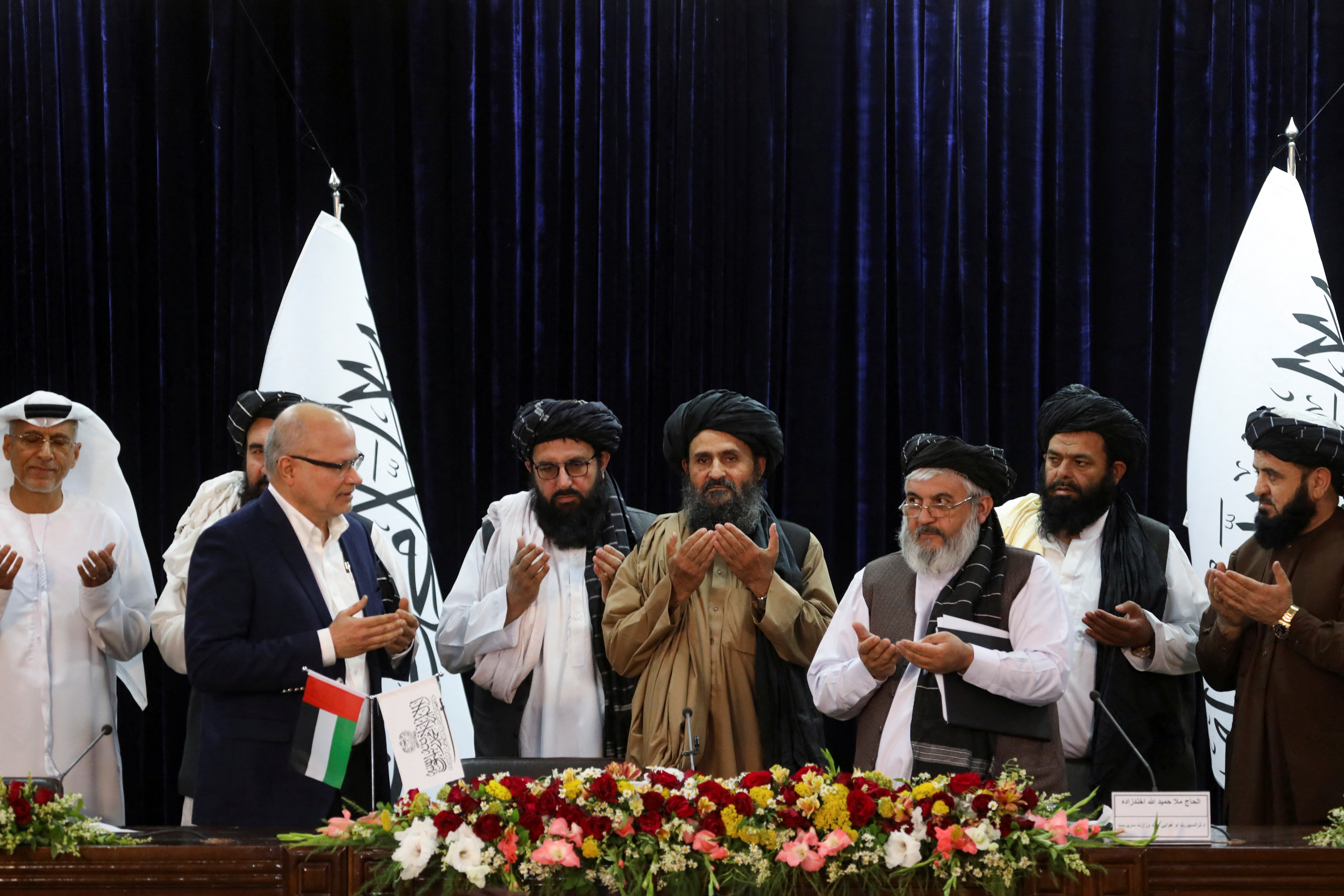 UAE firm CFO and Taliban pray at the end of signing ceremony in Kabul