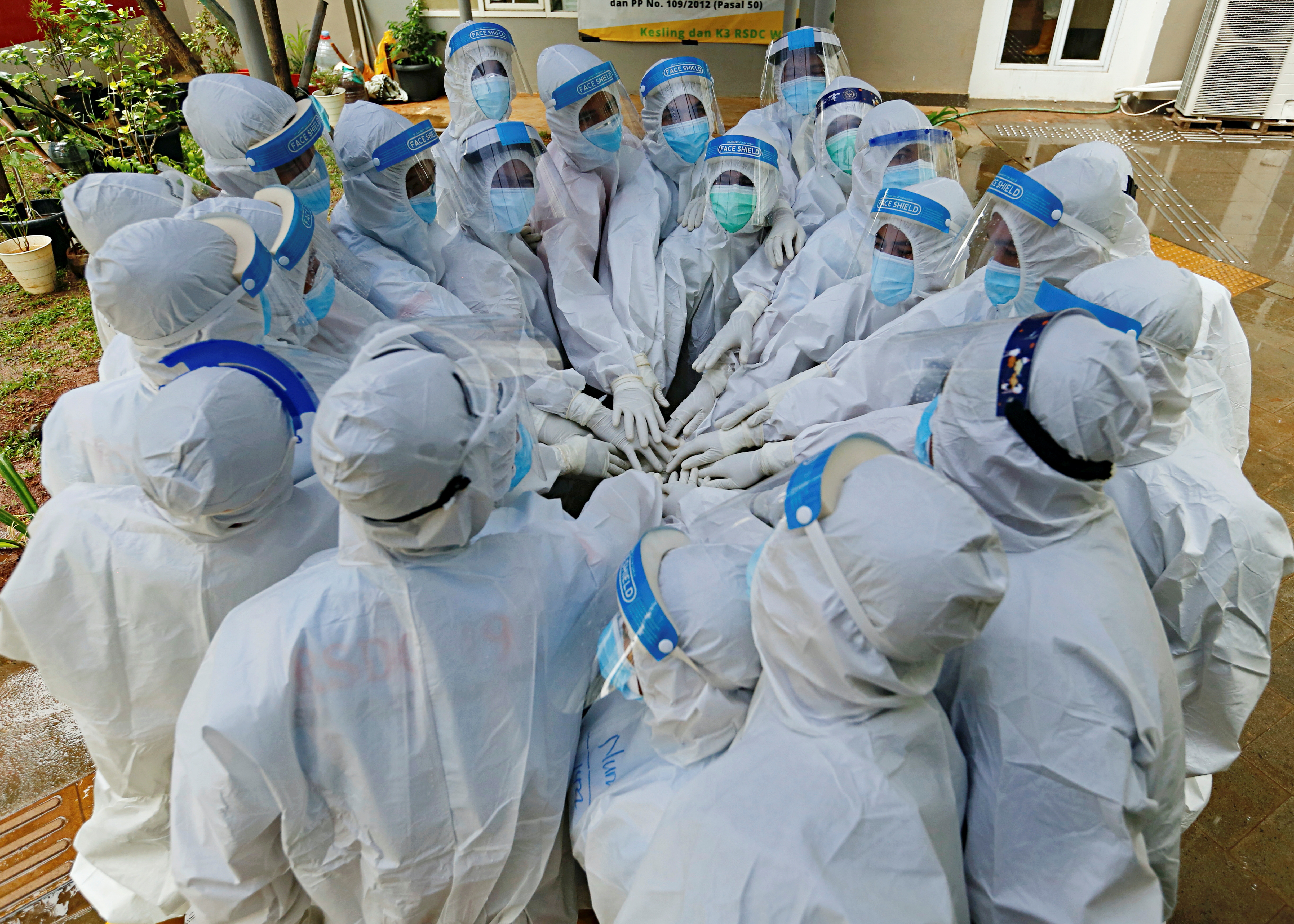 Healthcare workers wearing personal protective equipment (PPE) prepare to treat patients at the emergency hospital for coronavirus disease (COVID-19) in Athletes Village, Jakarta, Indonesia January 26, 2021. REUTERS/Ajeng Dinar Ulfiana