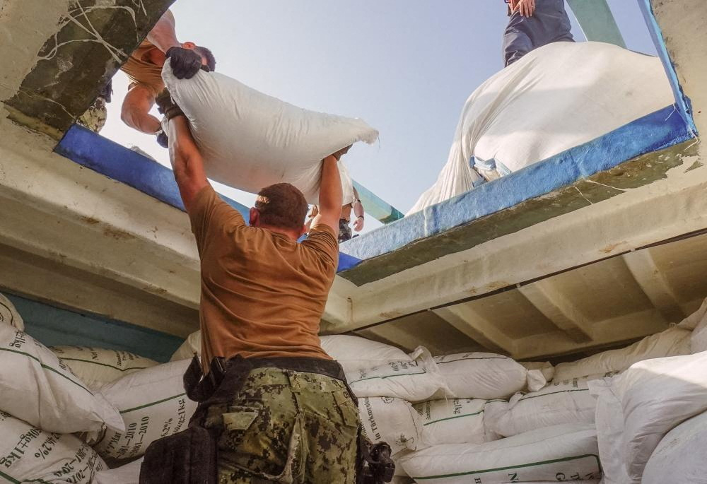 Sailors from USS The Sullivans (DDG 68) inventory a large quantity of urea fertiliser and ammonium perchlorate discovered on a fishing vessel intercepted by U.S. naval forces while transiting international waters in the Gulf of Oman