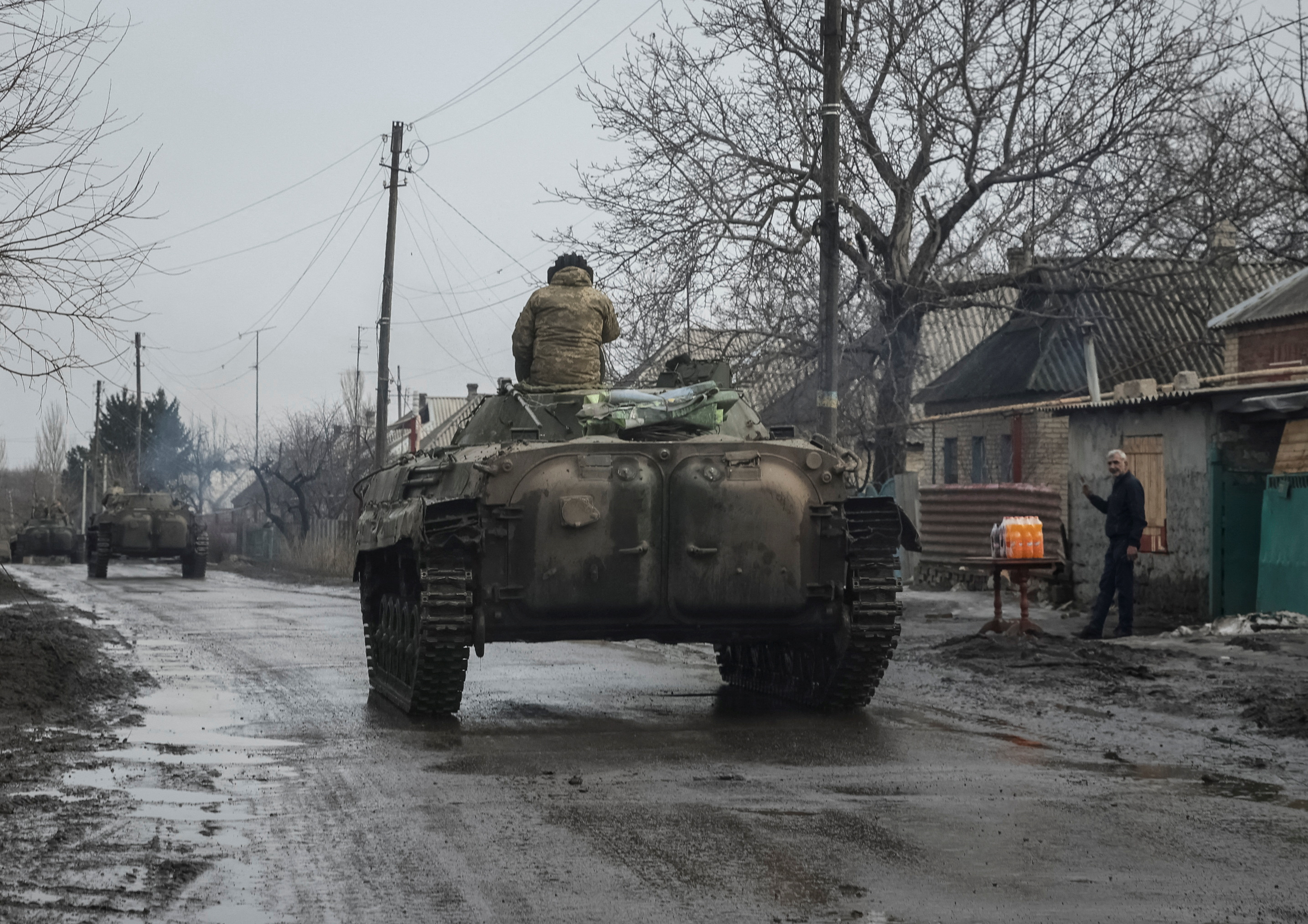 Ukrainian service members ride BMP-2 infantry fighting vehicles near Bakhmut