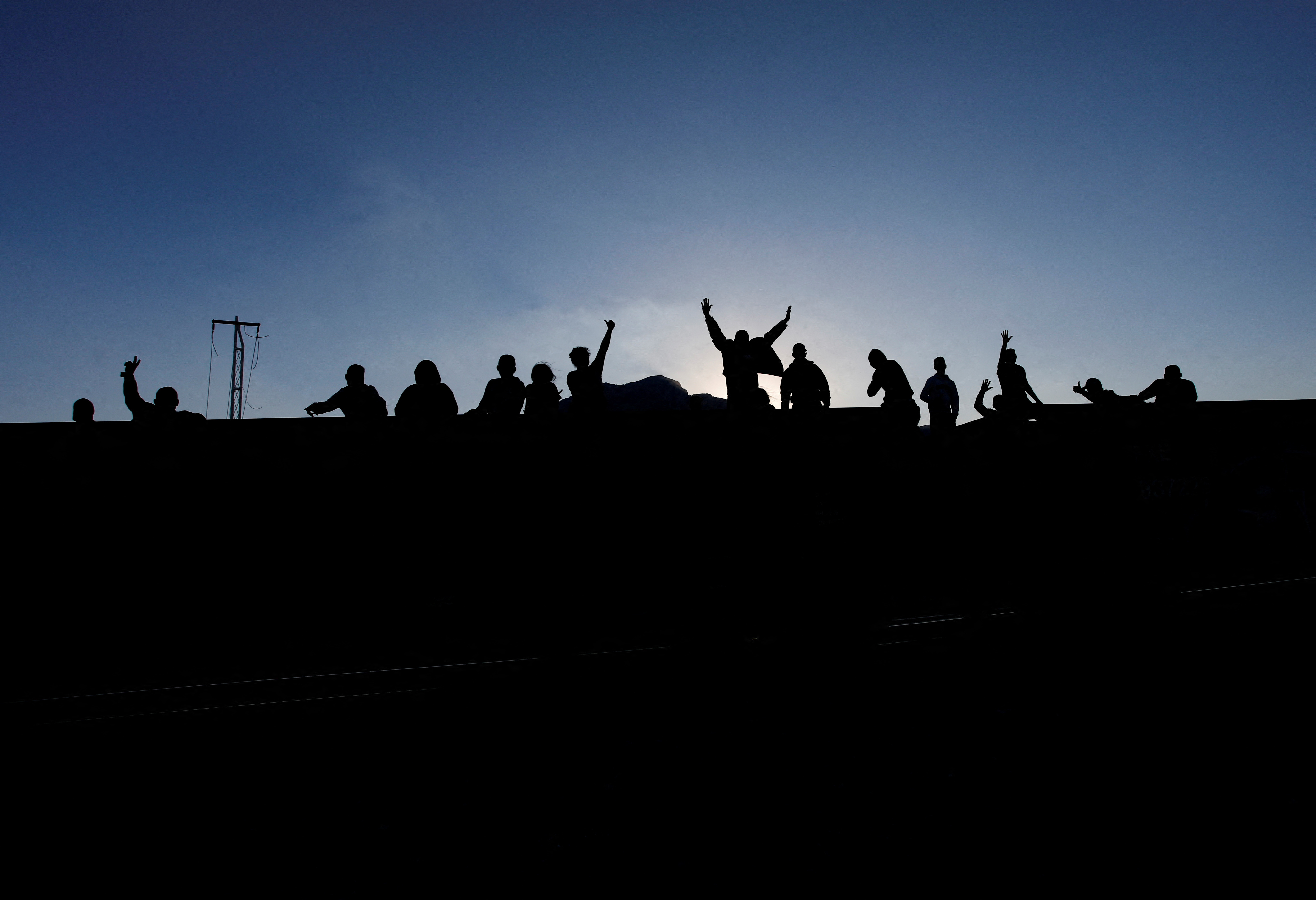 Asylum seekers heading to the U.S. travel on a train, in El Carmen