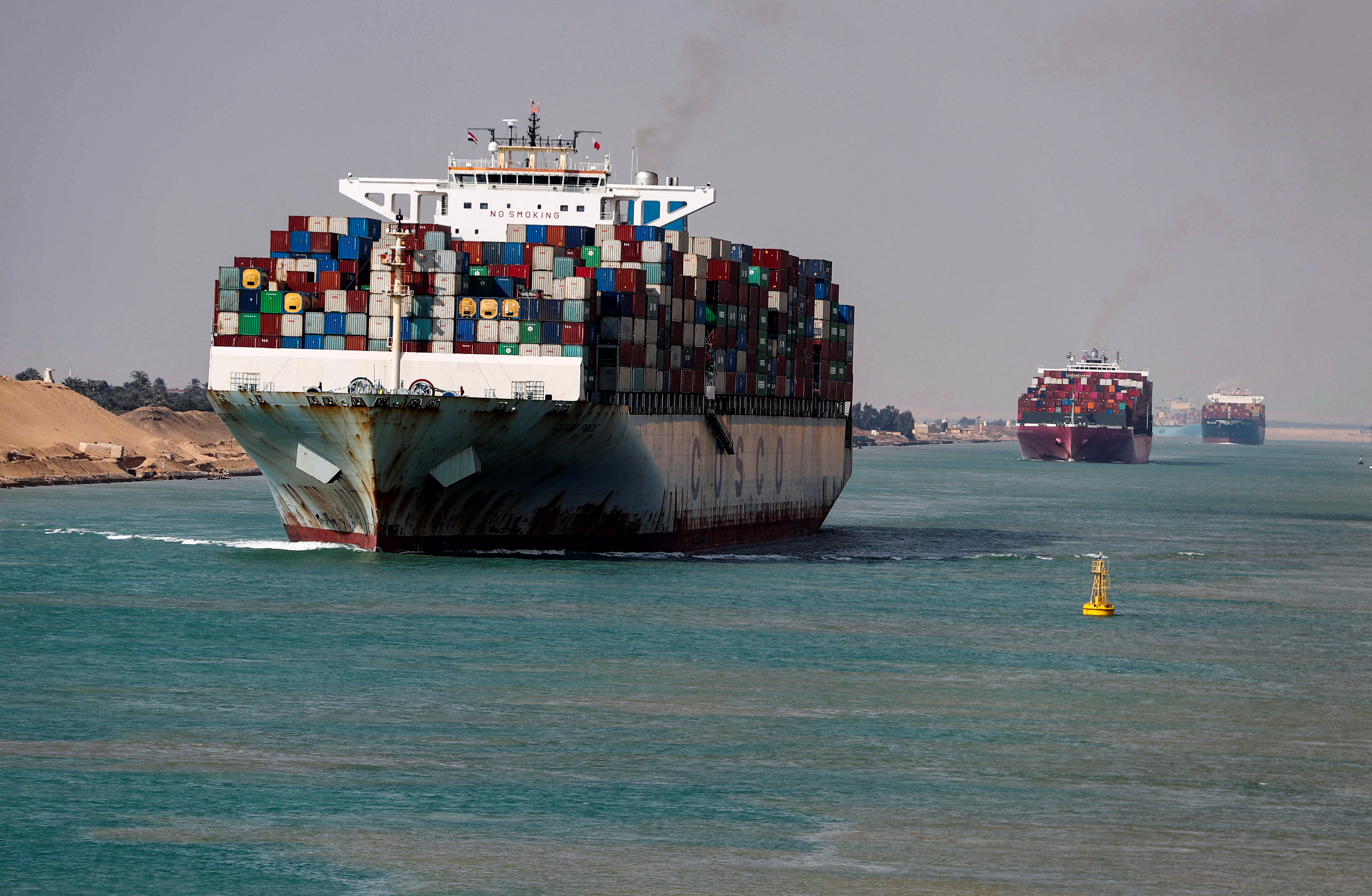 Shipping containers pass through the Suez Canal in Suez