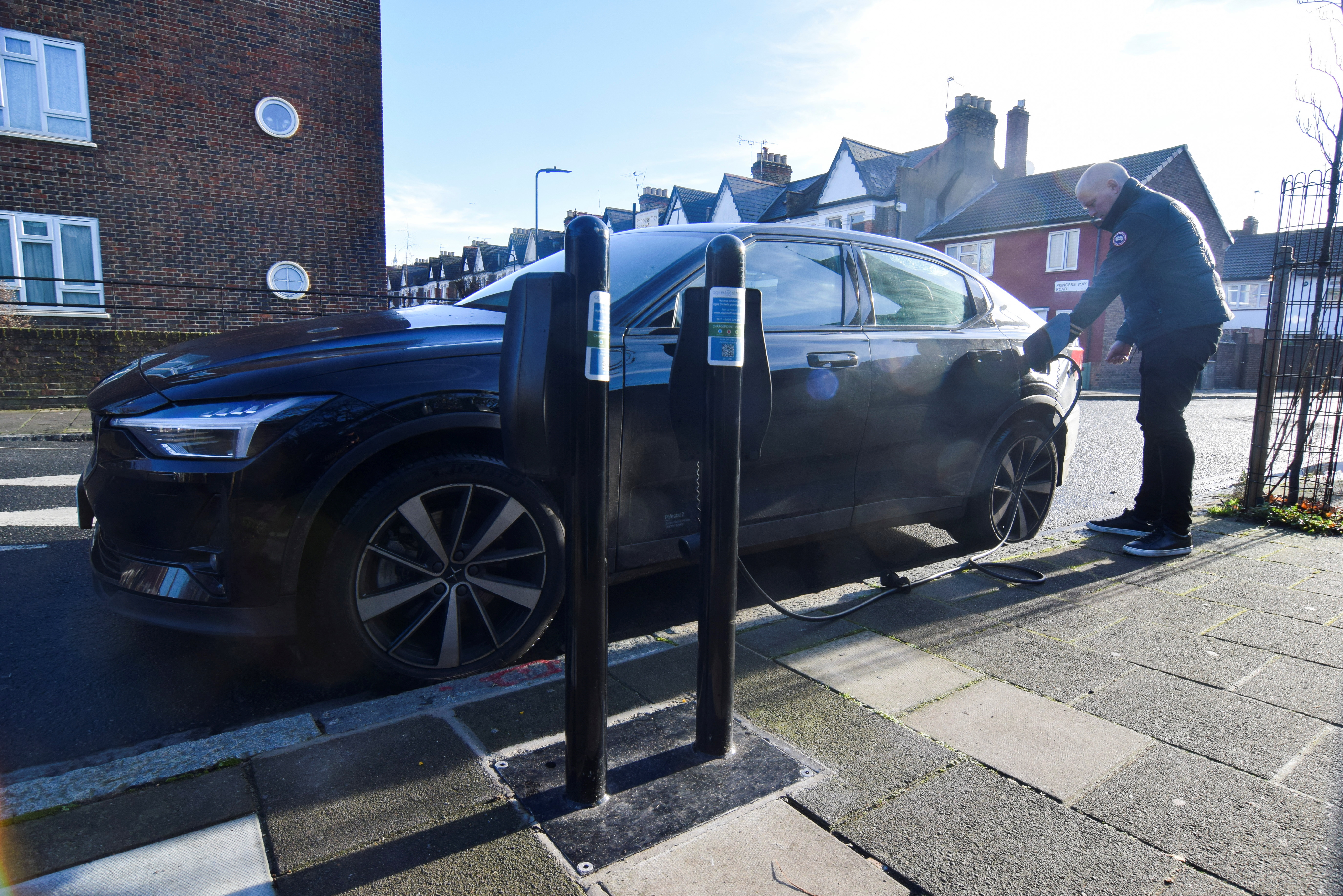 Connected Kerb CEO Chris Pateman-Jones plugs his electric vehicle into one of the charging infrastructure company's smart public on-street chargers in the borough of Hackney, London, Britain, January 12, 2022. REUTERS/Nick Carey
