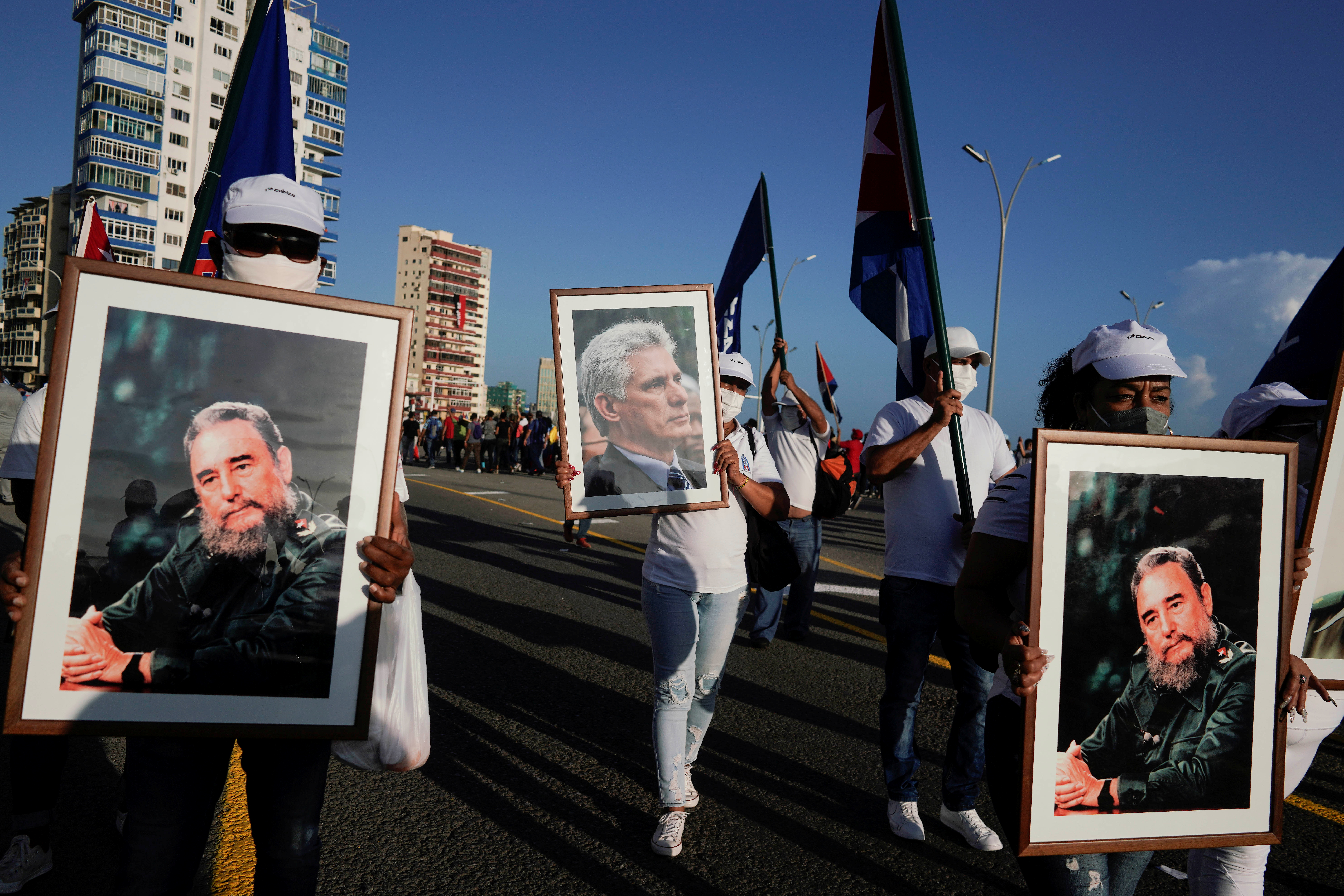People carry images of late Cuban President Fidel Castro and Cuba's President and First Secretary of the Communist Party Miguel Diaz-Canel during a rally in Havana, Cuba, July 17, 2021. REUTERS/Alexandre Meneghini 