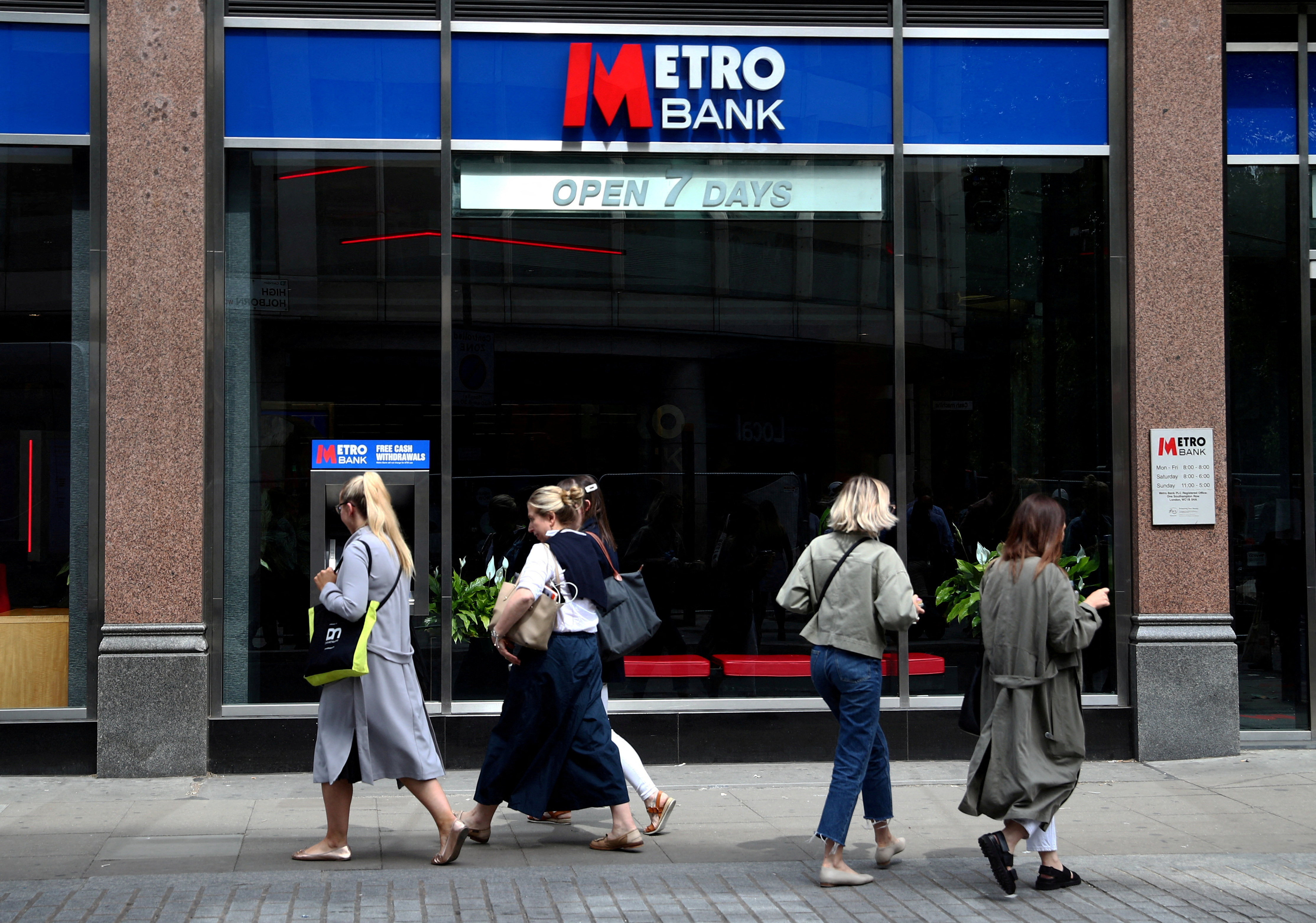 People walk past a Metro Bank in London