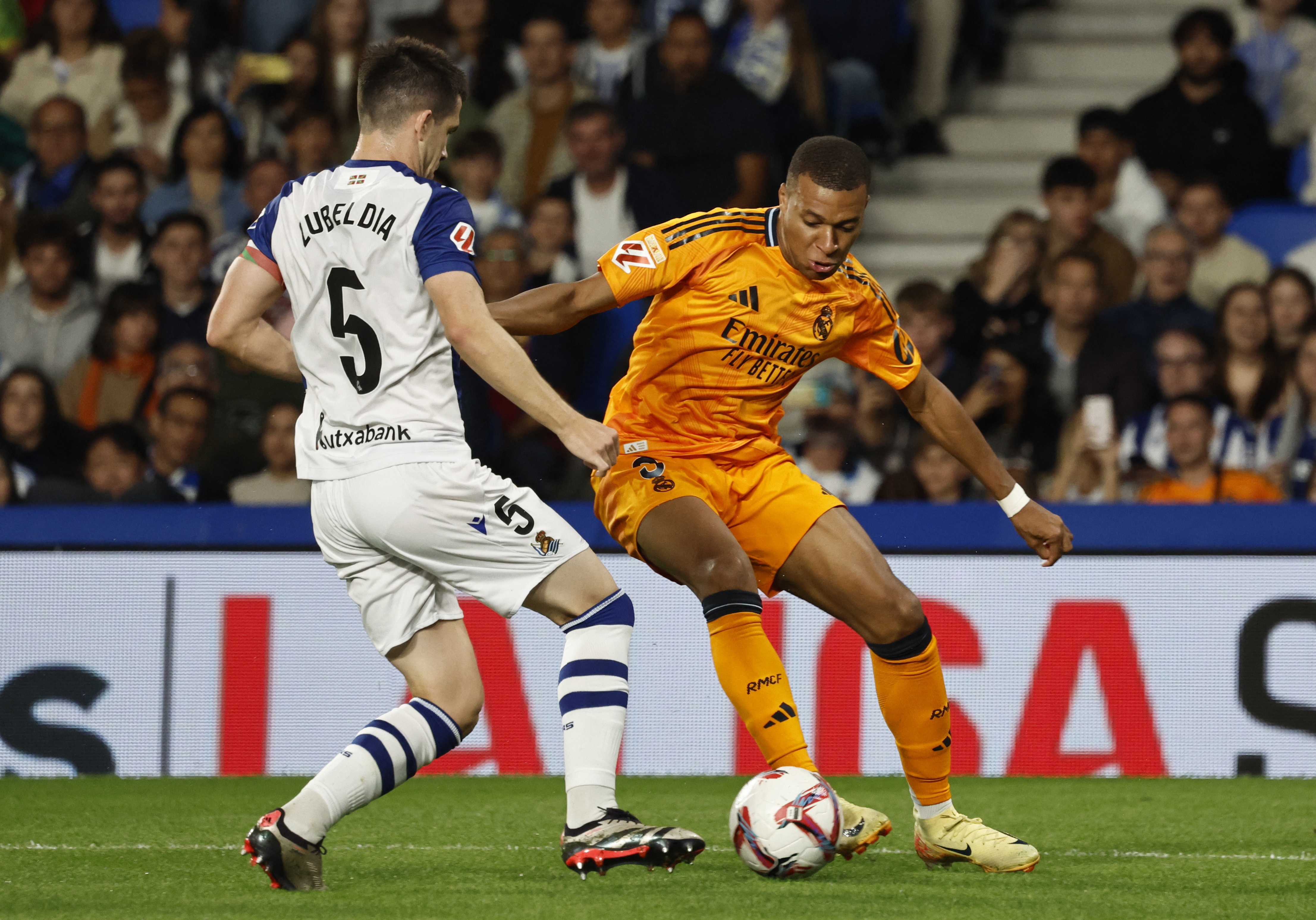 Soccer Football - LaLiga - Real Sociedad v Real Madrid - Reale Arena, San Sebastian, Spain - September 14, 2024 Real Madrid's Kylian Mbappe in action with Real Sociedad's Igor Zubeldia REUTERS/Vincent West