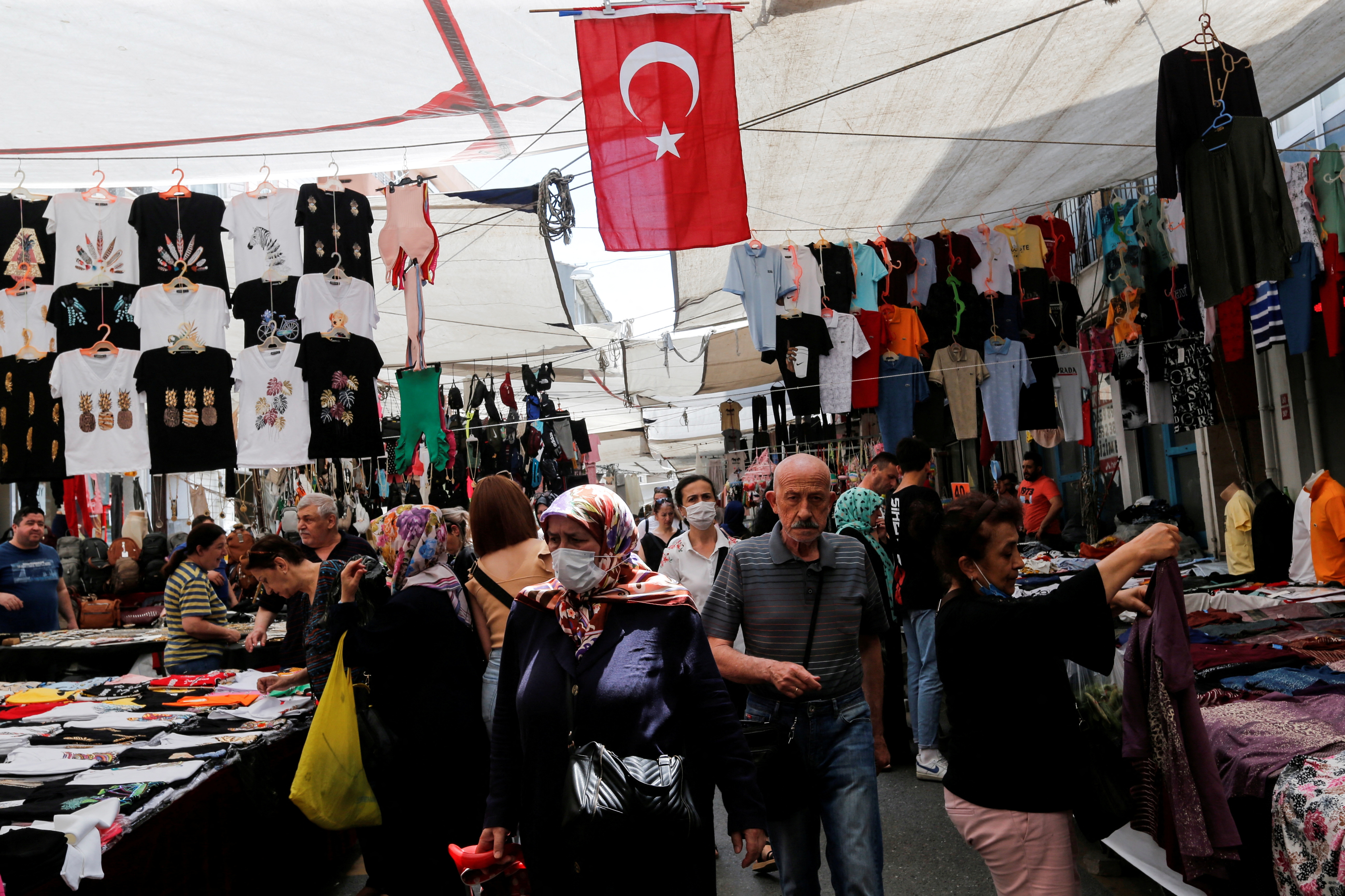 People shop at a open market in Istanbul
