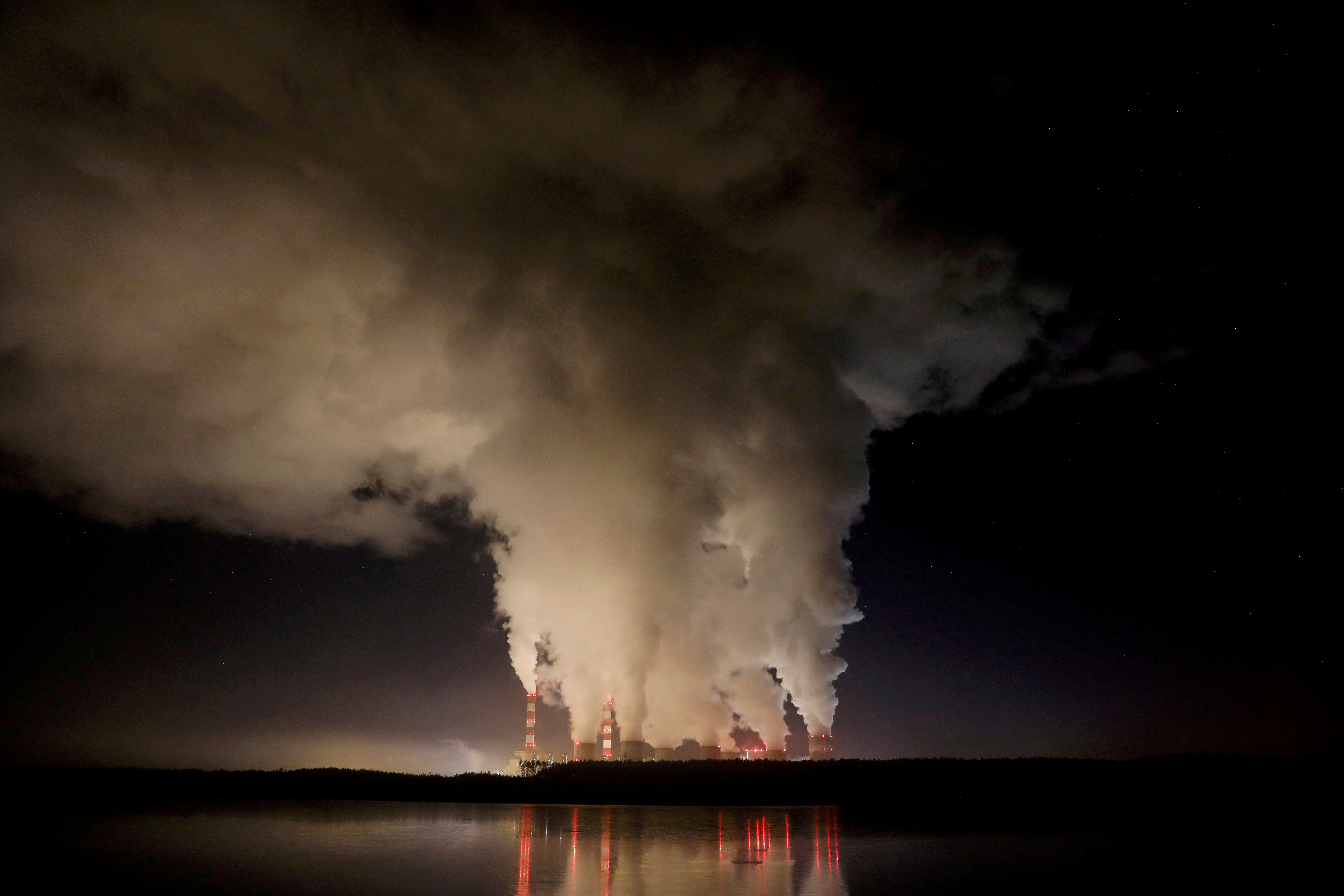Smoke and steam billow from Belchatow Power Station, Europe's largest coal-fired power plant, operated by PGE Group, at night near Belchatow, Poland December 5, 2018. REUTERS/Kacper Pempel/File Photo