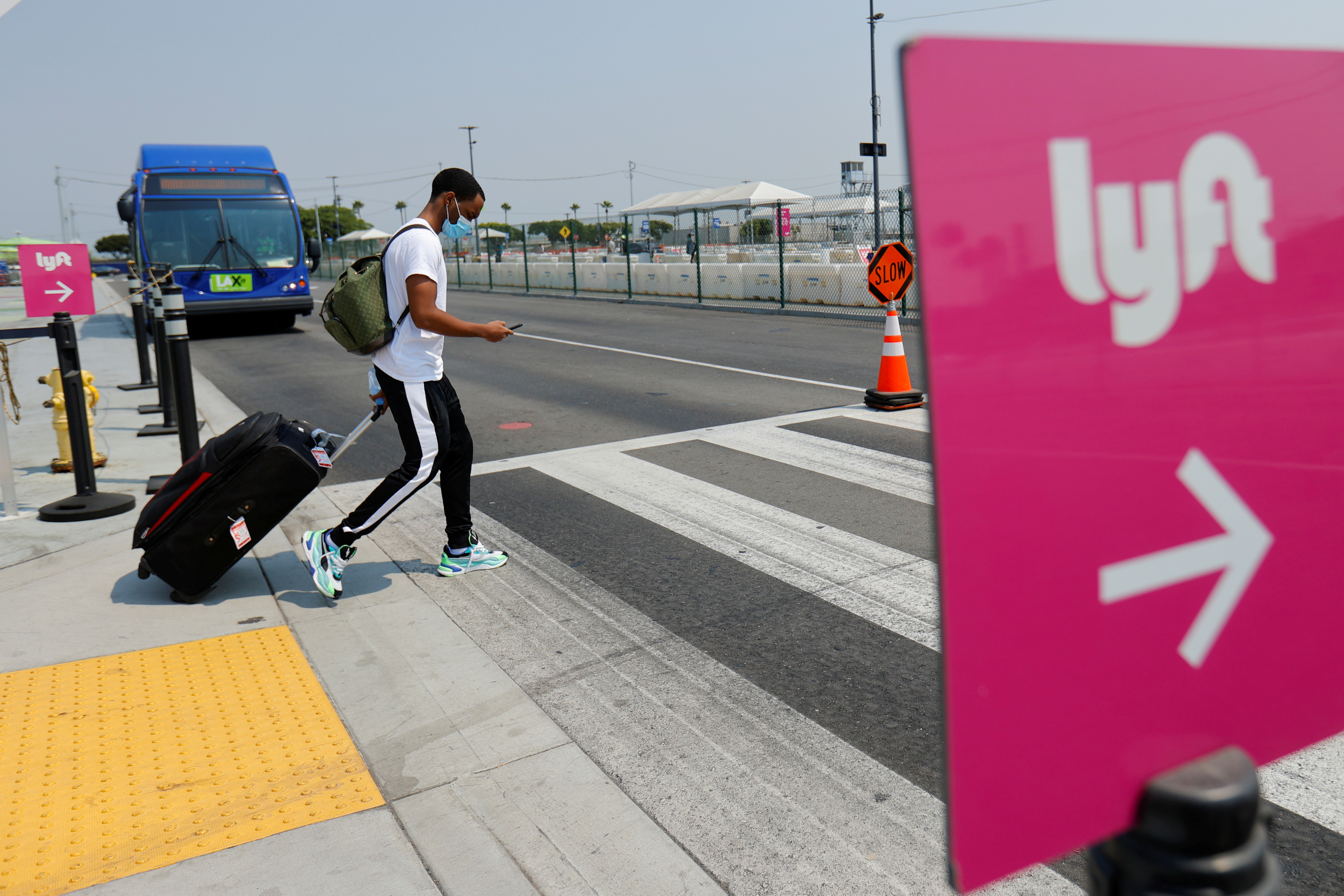 Traveler arrives as Uber and Lyft drivers demonstrate over basic employee rights in California