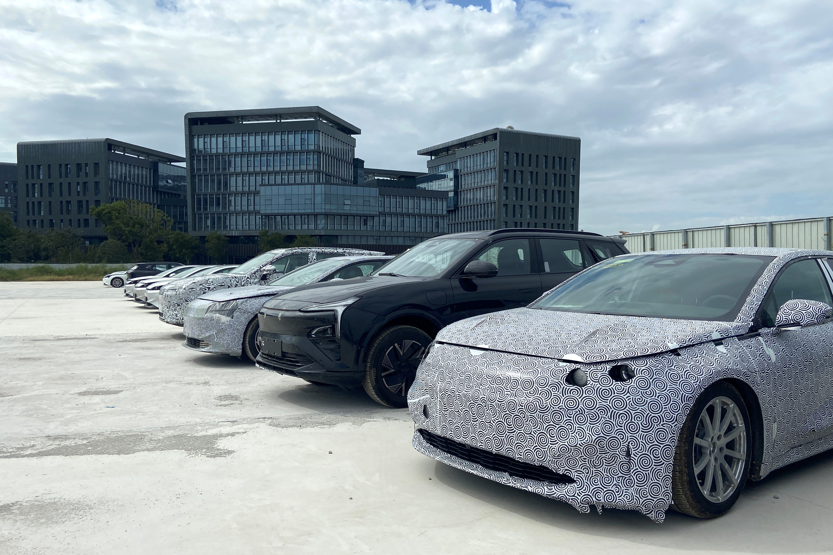 Test cars by Evergrande are parked outside the Evergrande NEV's research center in Shanghai