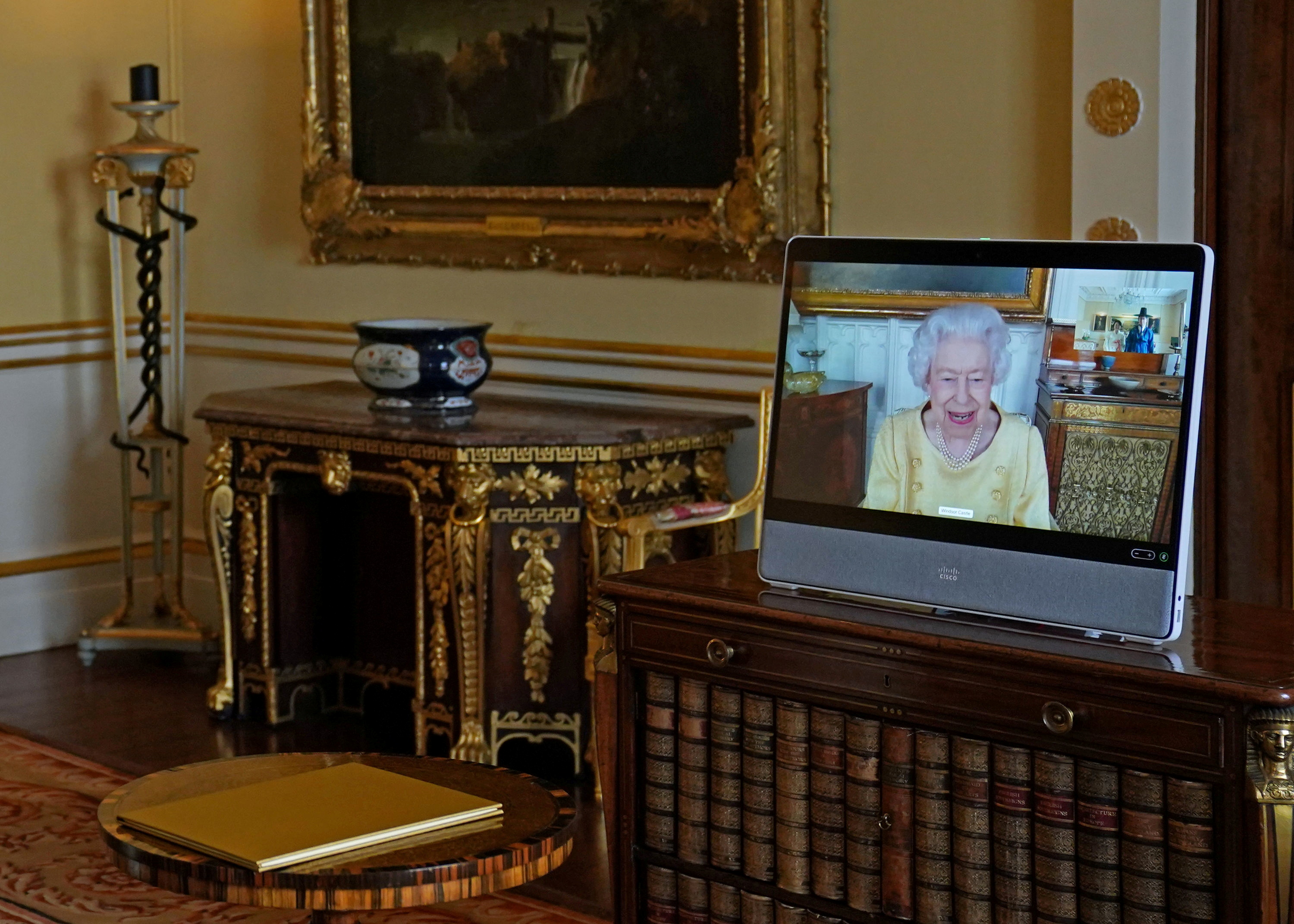 Britain's Queen Elizabeth appears on a screen via video link from Windsor Castle, where she is in residence, during a virtual audience to receive the Ambassador from the Republic of Korea, Gunn Kim, at Buckingham Palace, London, Britain, October 26, 2021. Victoria Jones/Pool via REUTERS