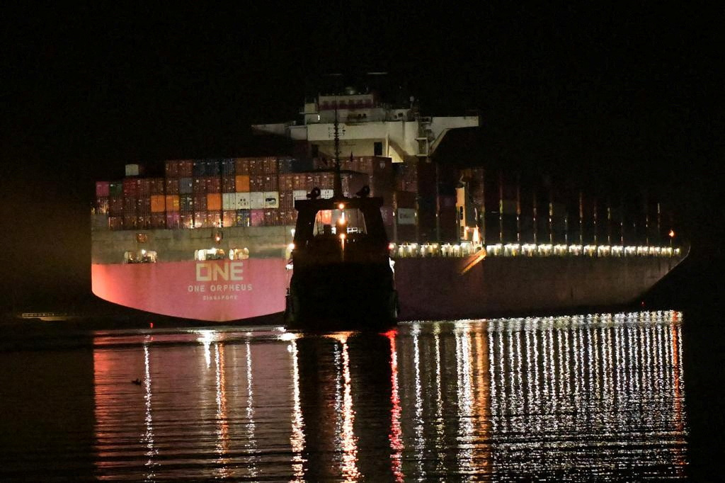 A Suez Canal Authority (SCA) tugboat works to salvage a navigational emergency and technical malfunction sustained by a container vessel 'ONE ORPHEUS' during its transit through the Suez Canal