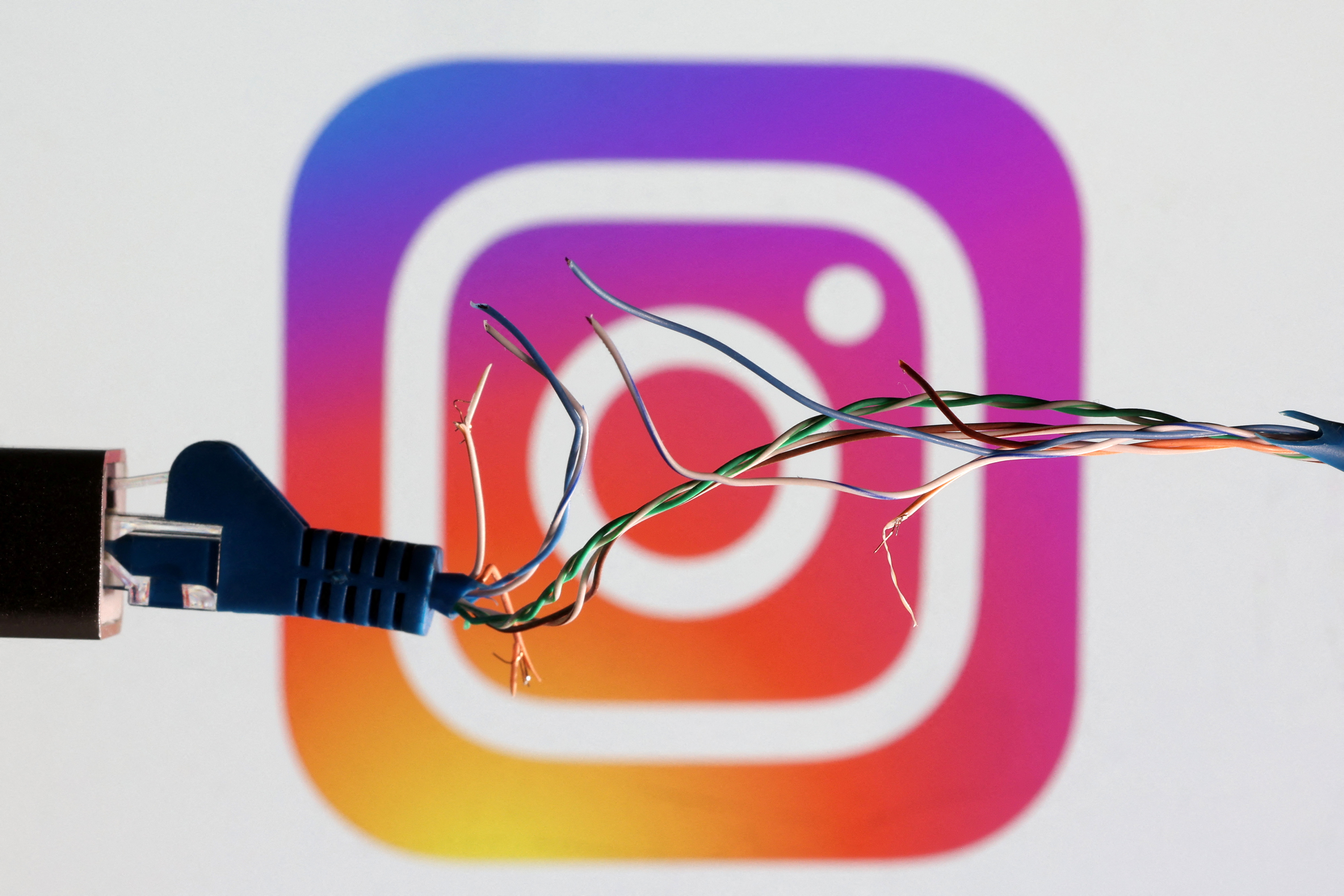 Illustration shows broken Ethernet cable and Instagram logo