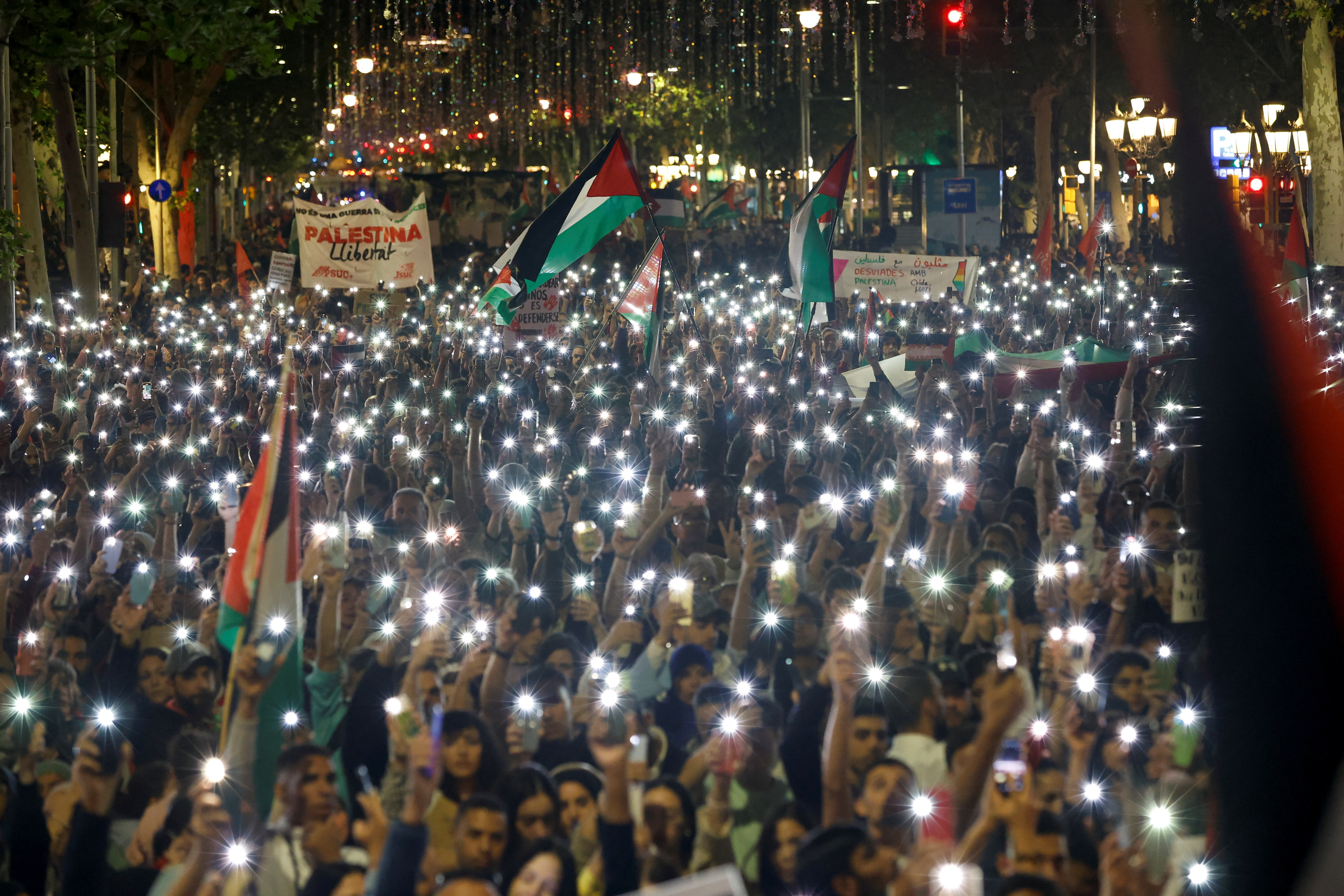 Members of the Palestinian community participate in a demonstration in Barcelona