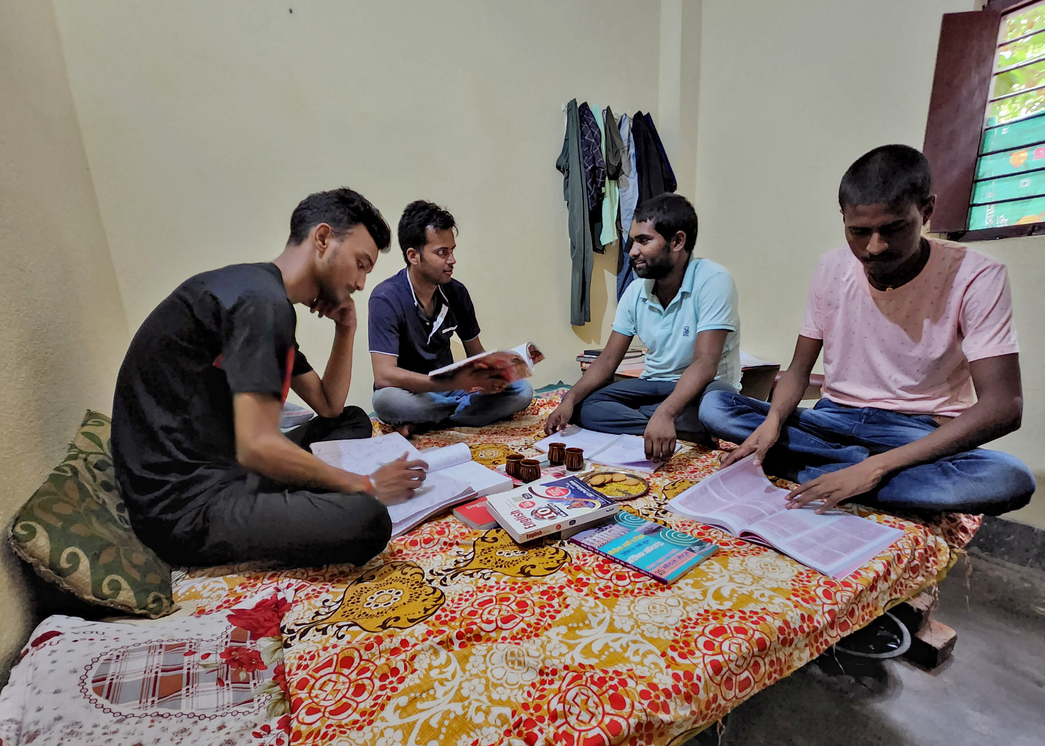 Government job aspirants Rahul Patel, Prem Prakash, Ravi Ranjan and Gupteshwar Kumar take part in a group study as they prepare for railway job in a rented room in Arrah