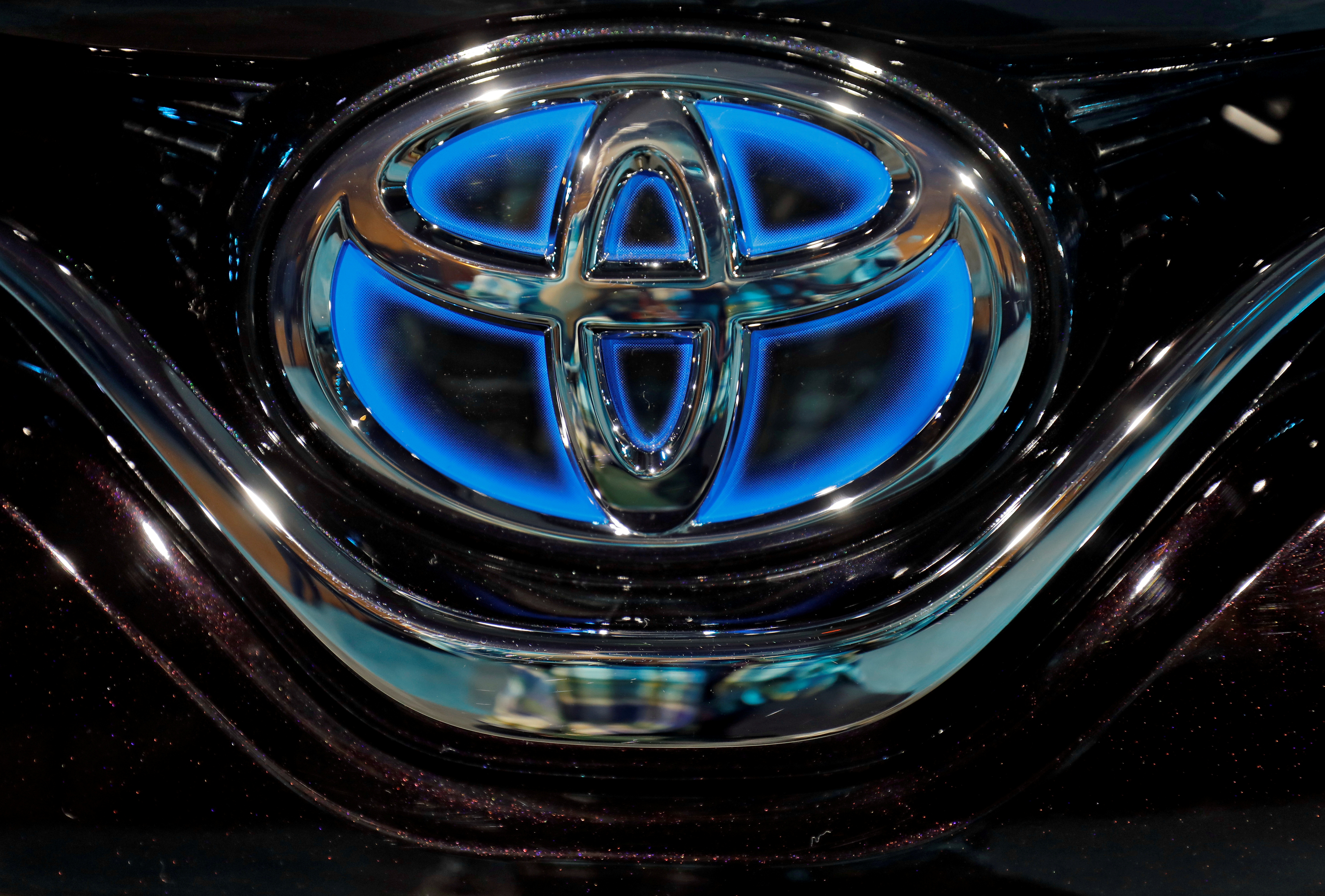 The Toyota logo is seen on the bonnet of a newly launched Camry Hybrid electric vehicle at a hotel in New Delhi